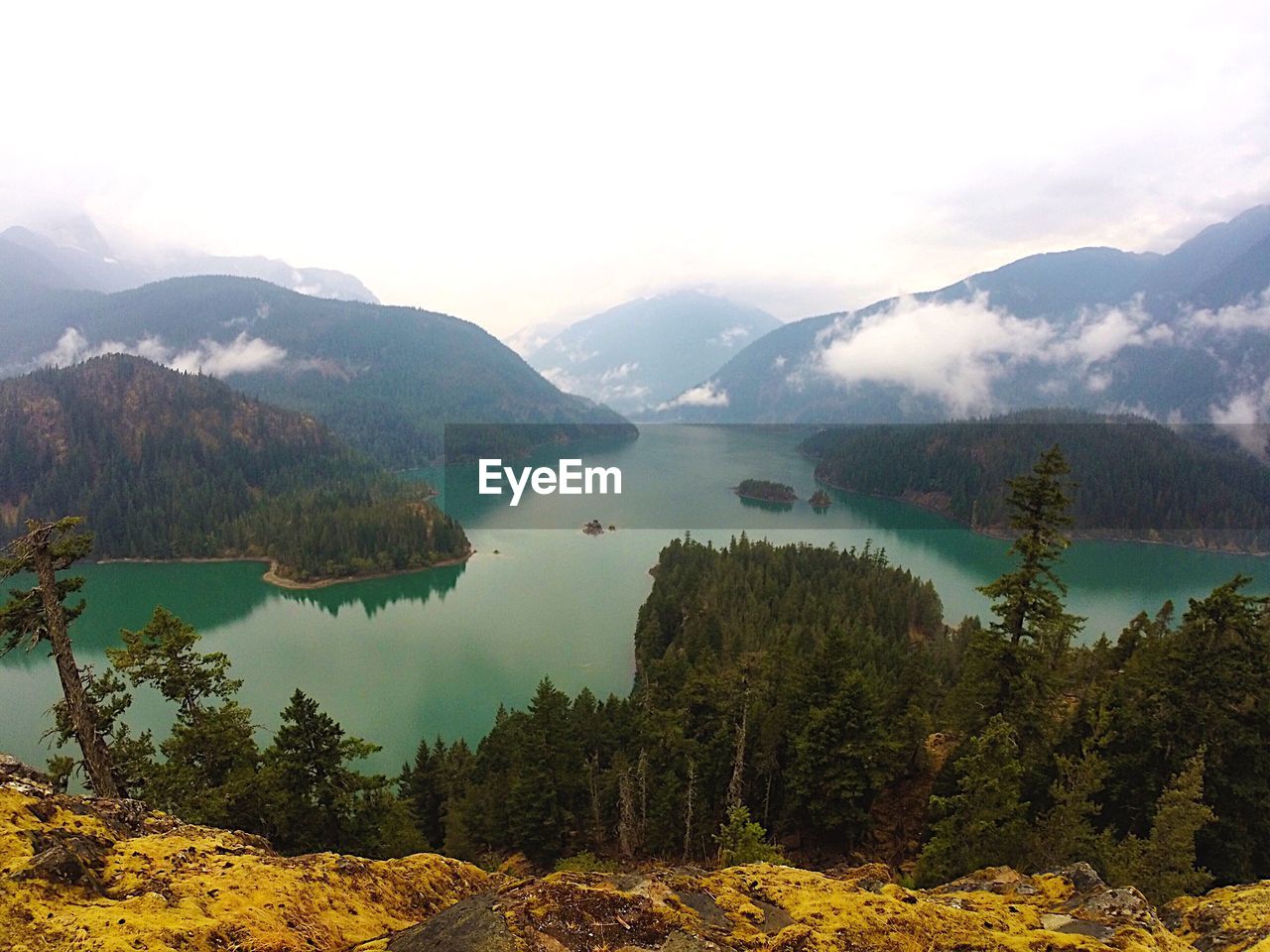 Scenic view of lake and mountains against sky