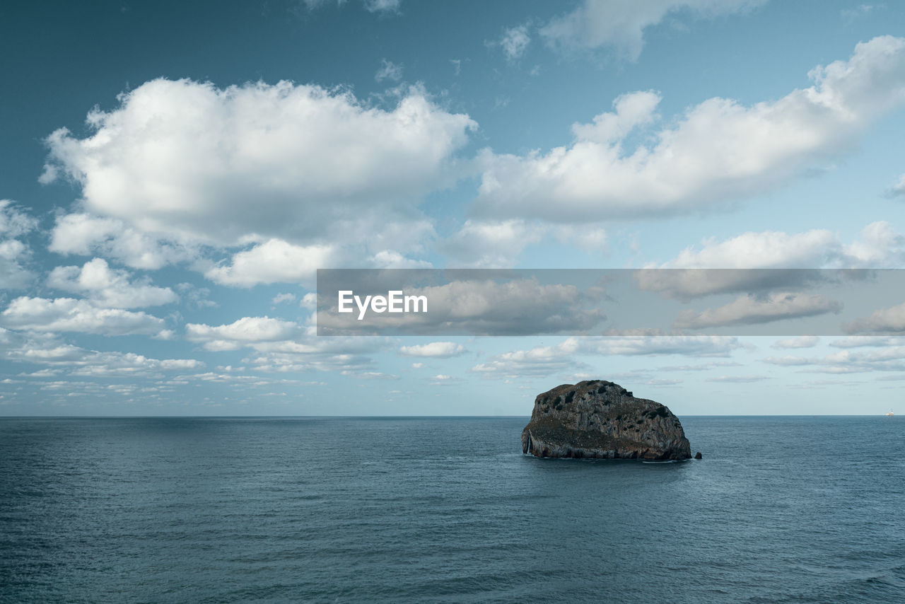 Scenic view of a rock in the sea against sky