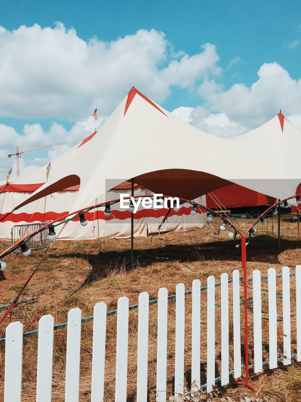 Circus tents on field against sky