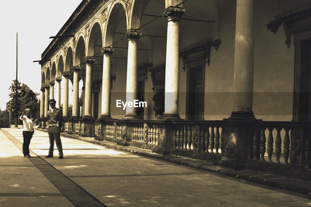 WOMAN WALKING ON STREET IN CITY