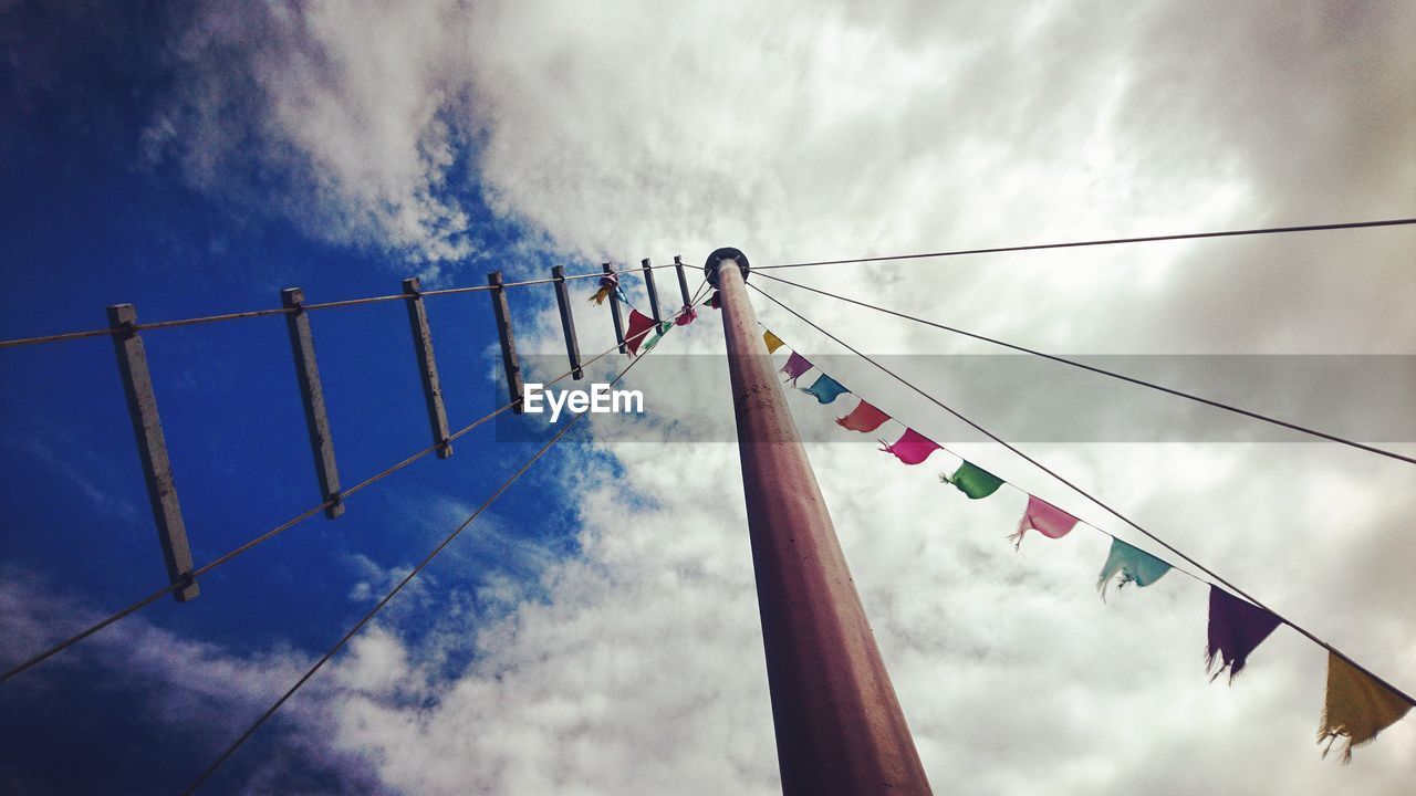 cloud - sky, sky, hanging, nature, low angle view, flag, day, no people, outdoors, rope, decoration, patriotism, built structure, architecture, pole, clothing, in a row, cable, connection