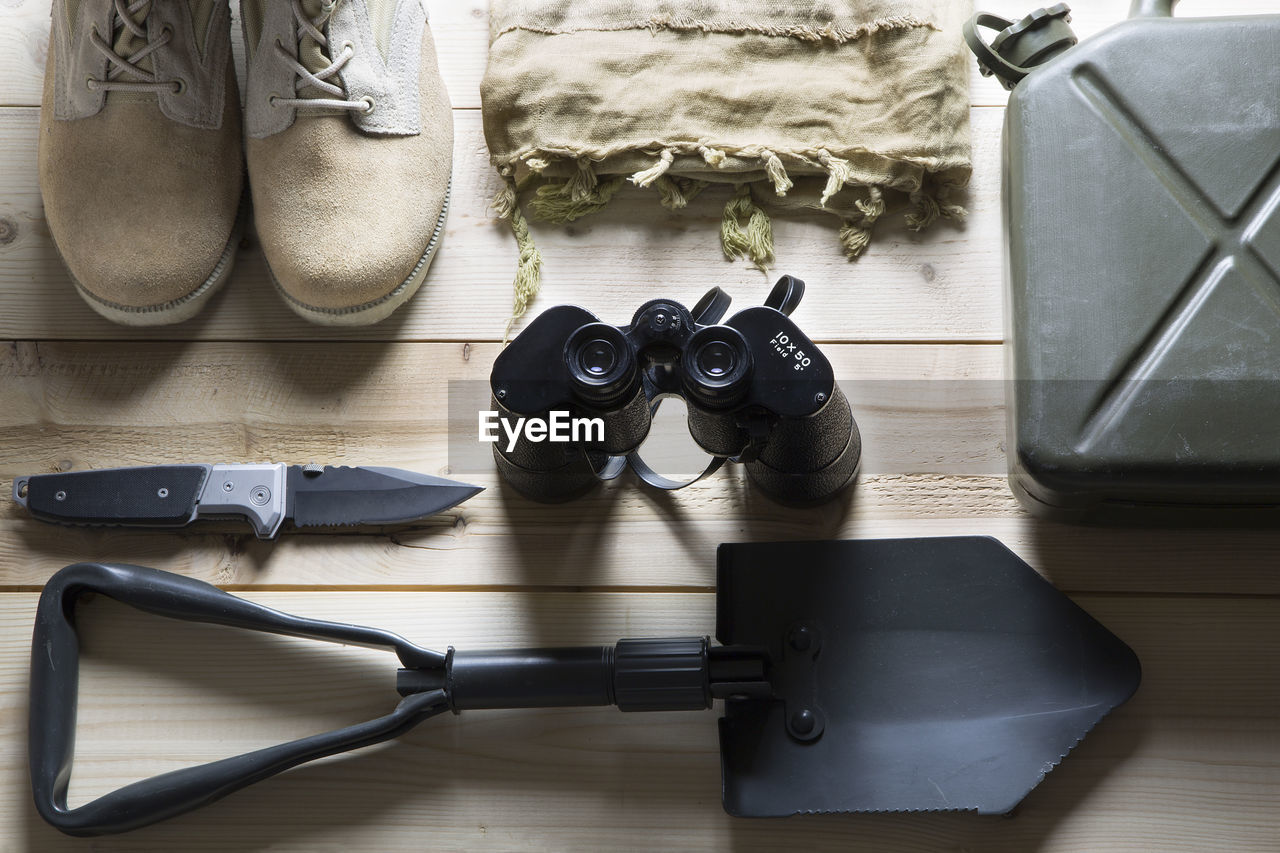 High angle view of hiking equipment arranged on wooden table