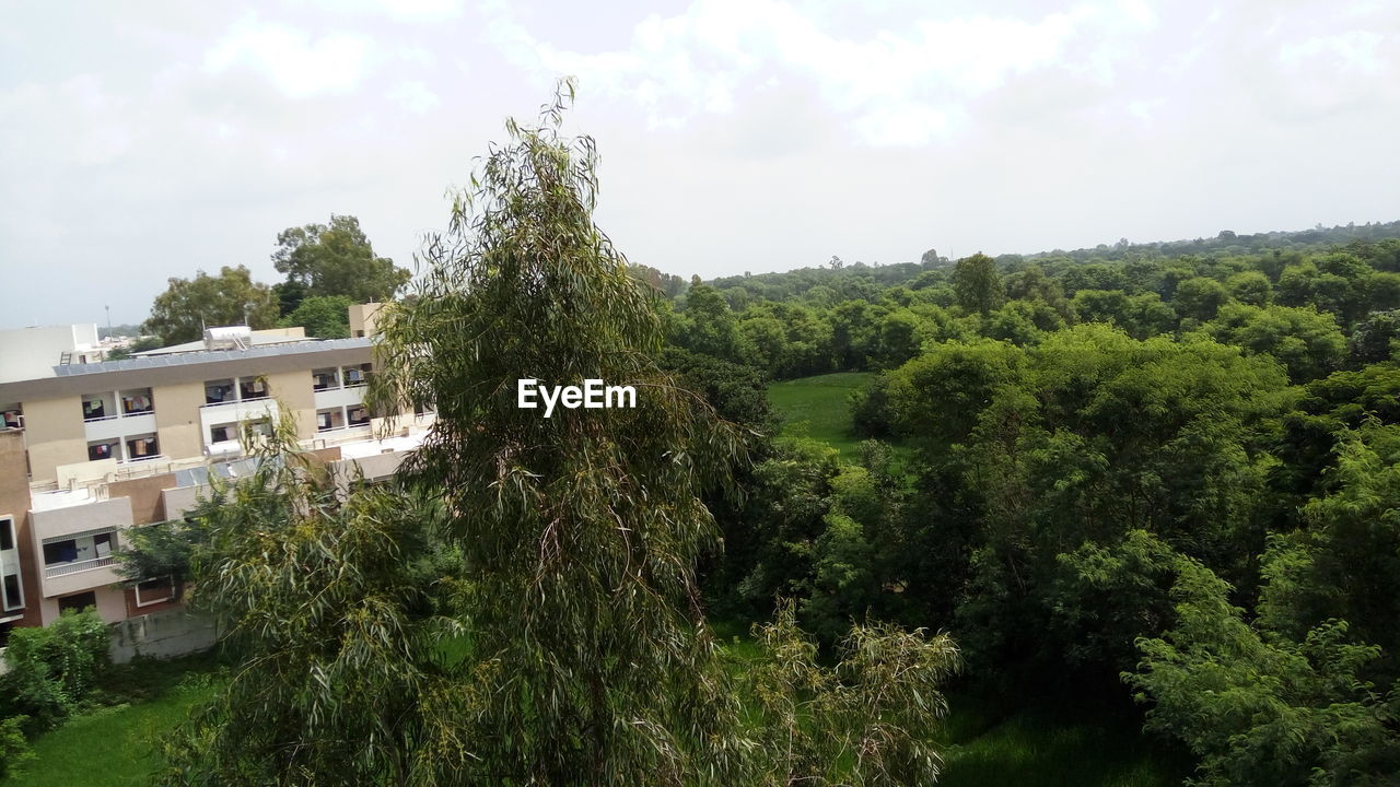 VIEW OF HOUSE AGAINST CLOUDY SKY