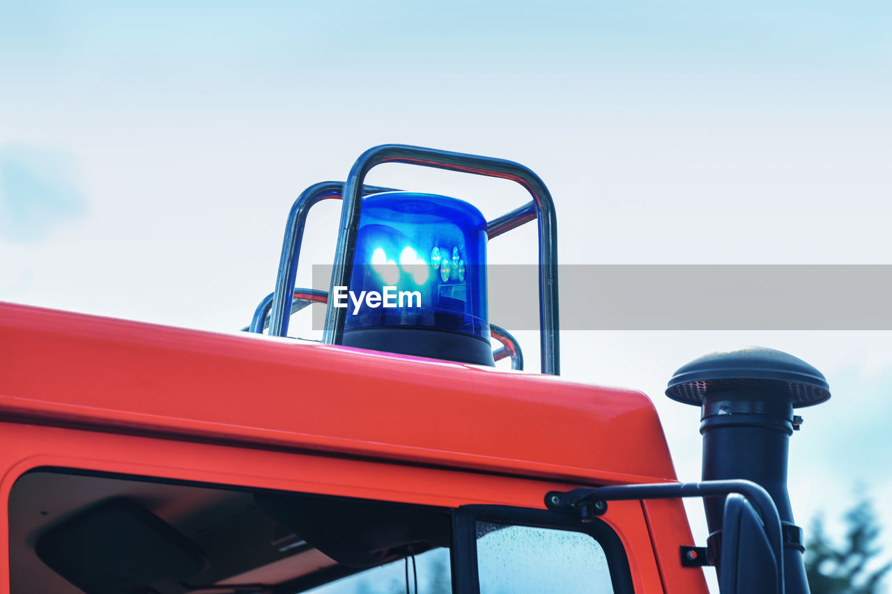 red, vehicle, transportation, blue, mode of transportation, sky, nature, day, low angle view, outdoors, no people, land vehicle