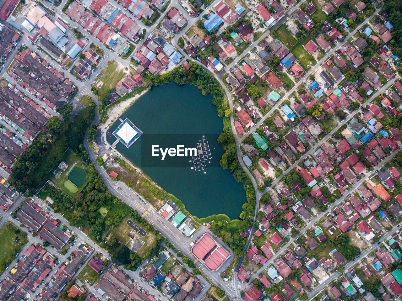 Aerial view of lake amidst houses in town