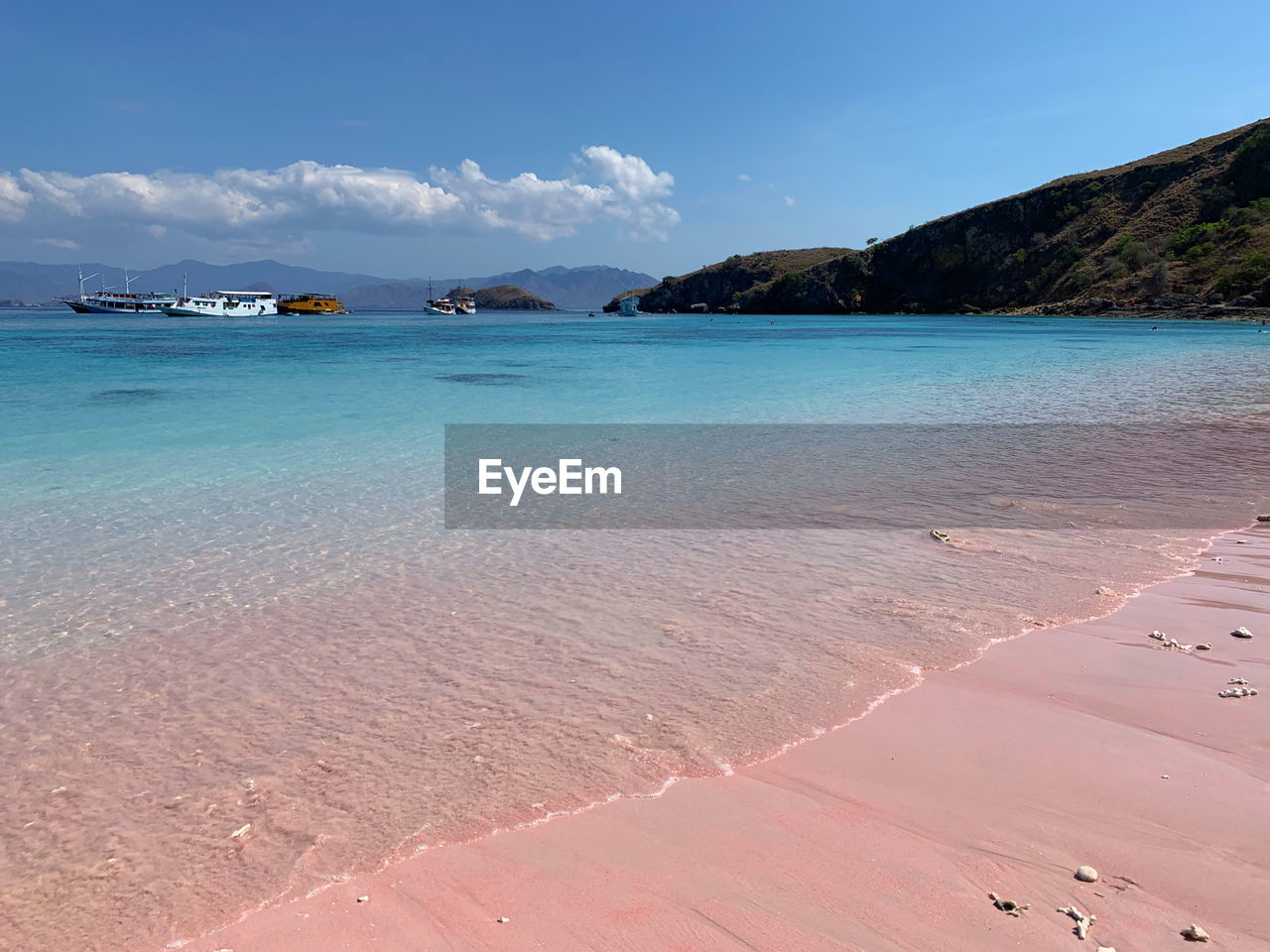 Scenic view of sea against sky as t the pink long beach on komodo island 