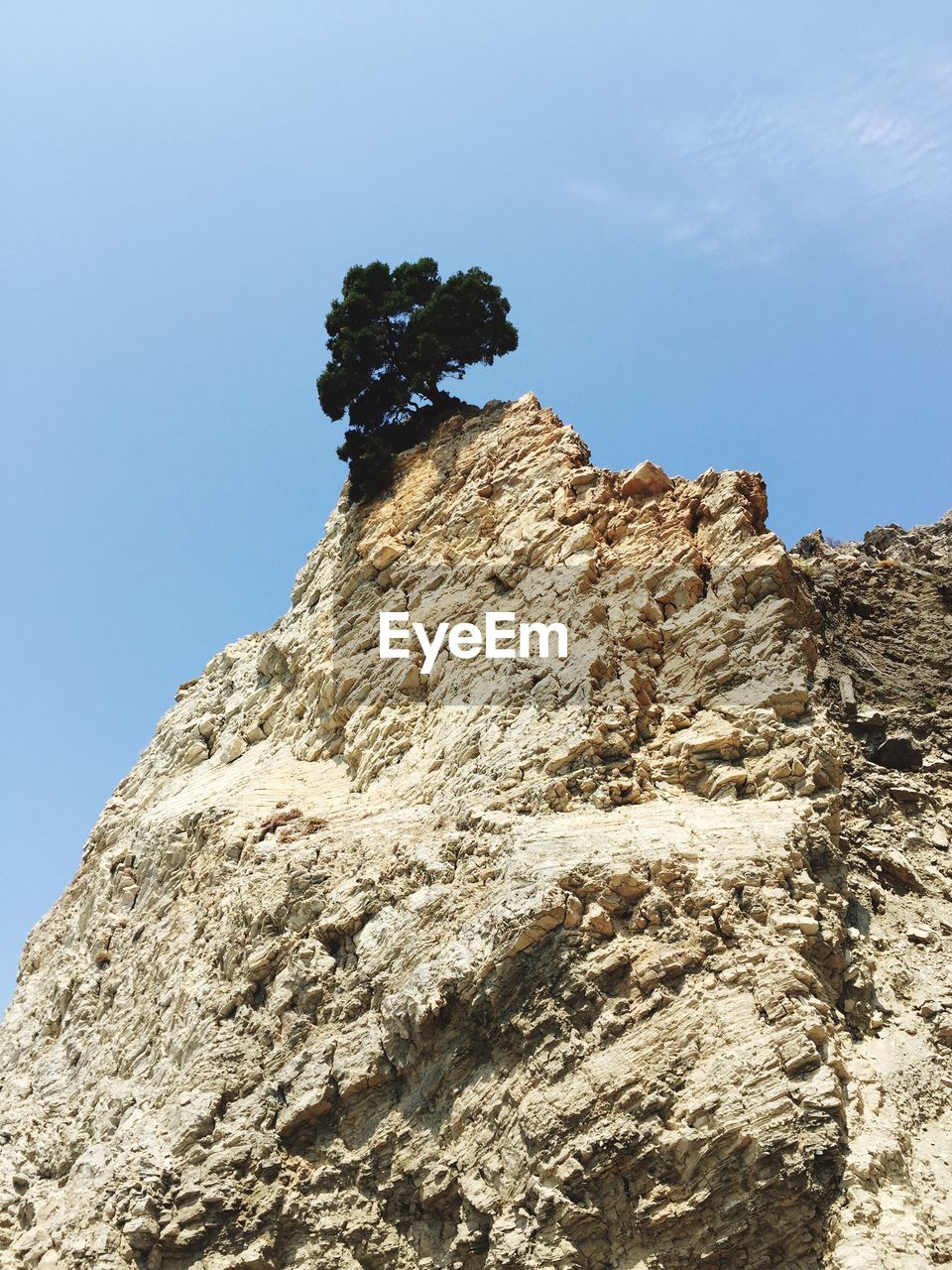 Low angle view of cliff against sky