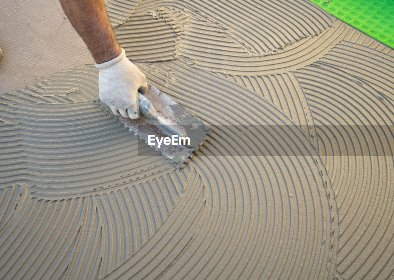 Low angle view of man working on wood