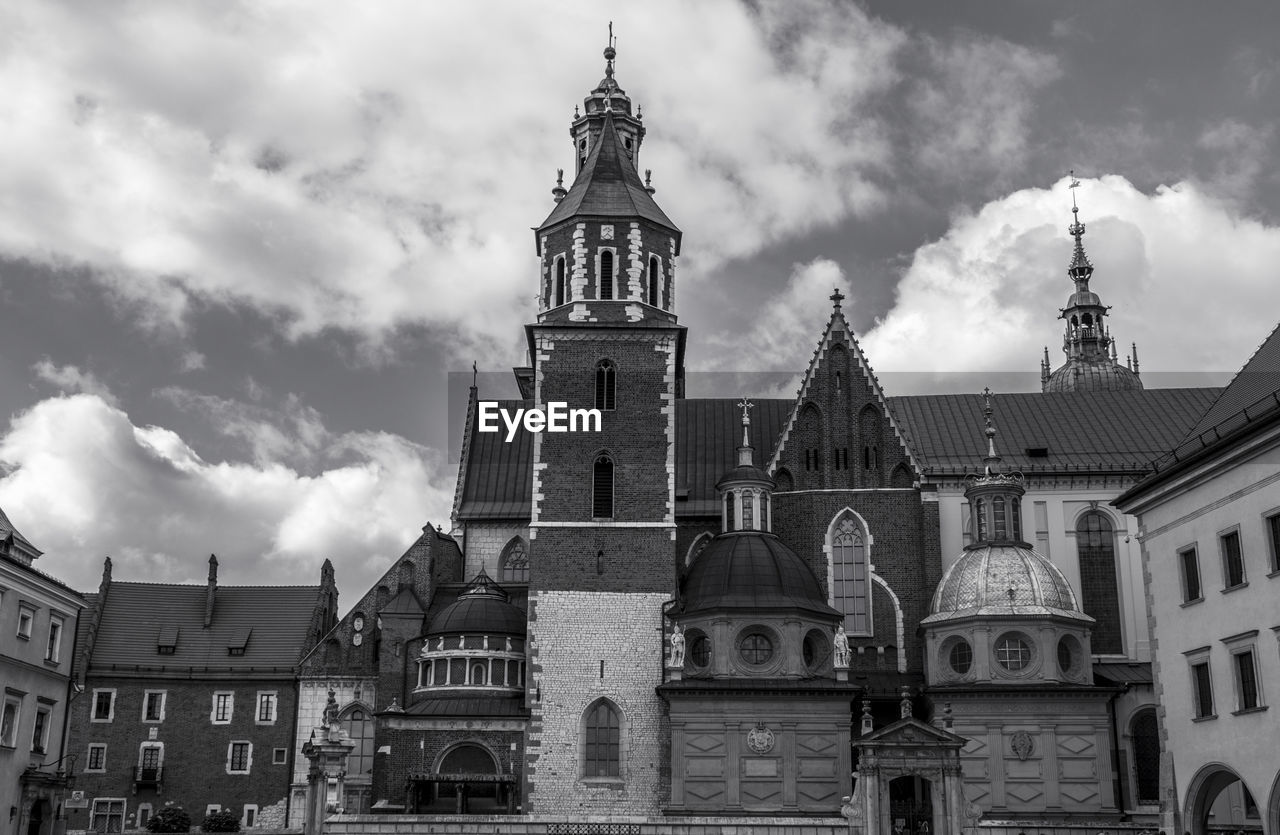 Low angle view of wawel castle against cloudy sky