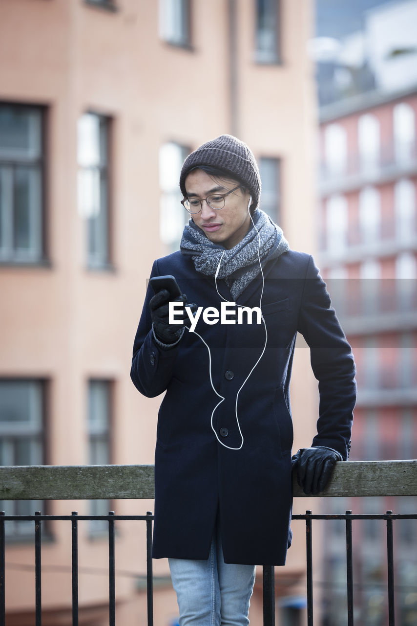 Handsome man with smartphone on street