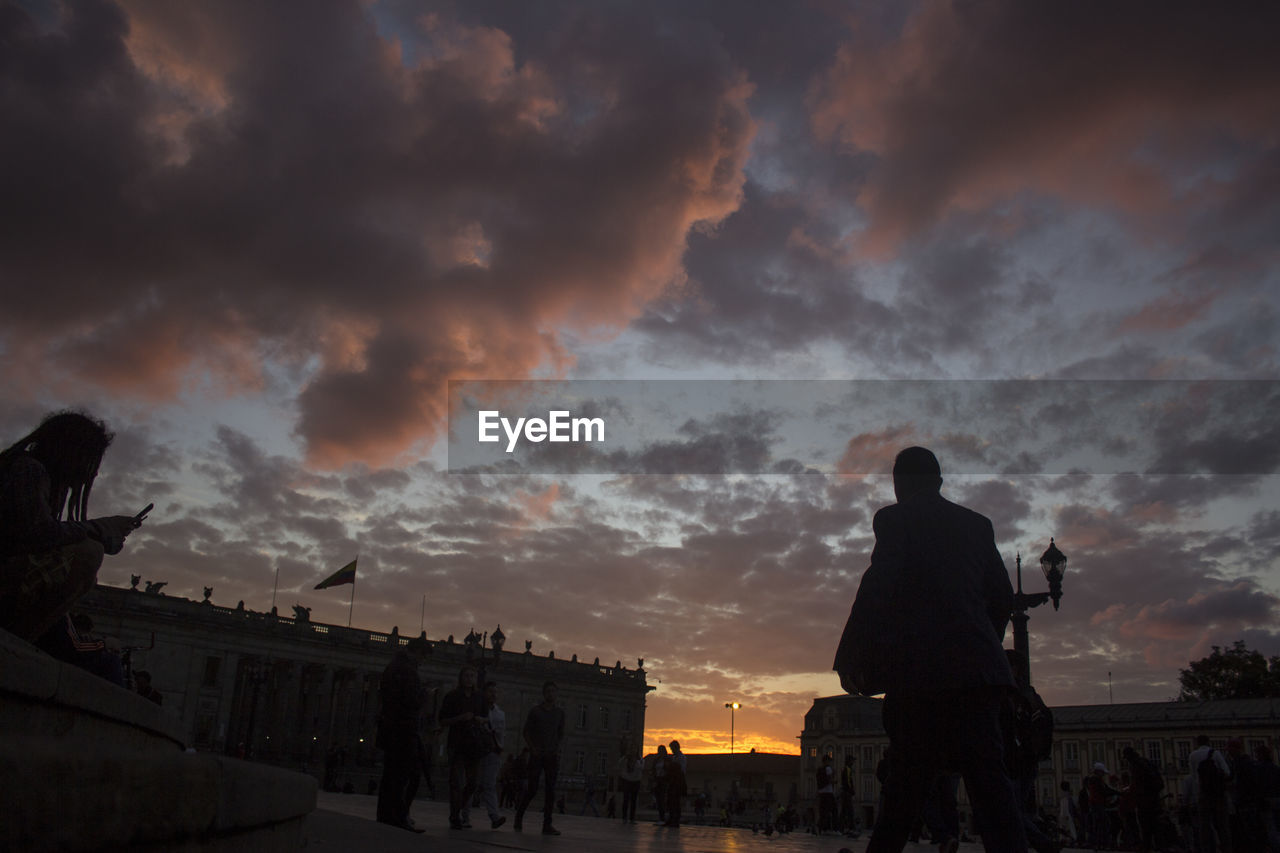 Silhouette of buildings against cloudy sky