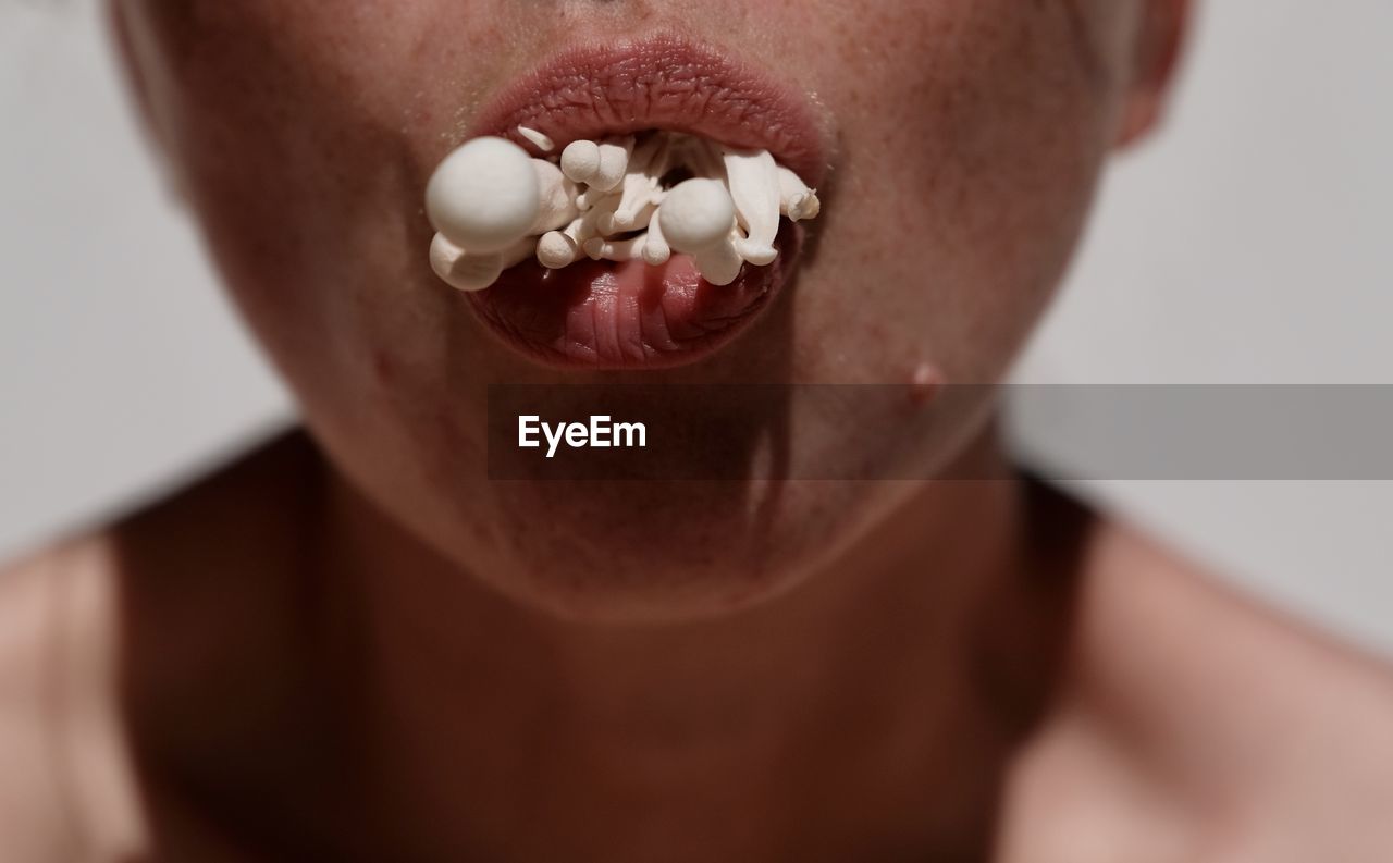 Close-up of woman eating mushroom