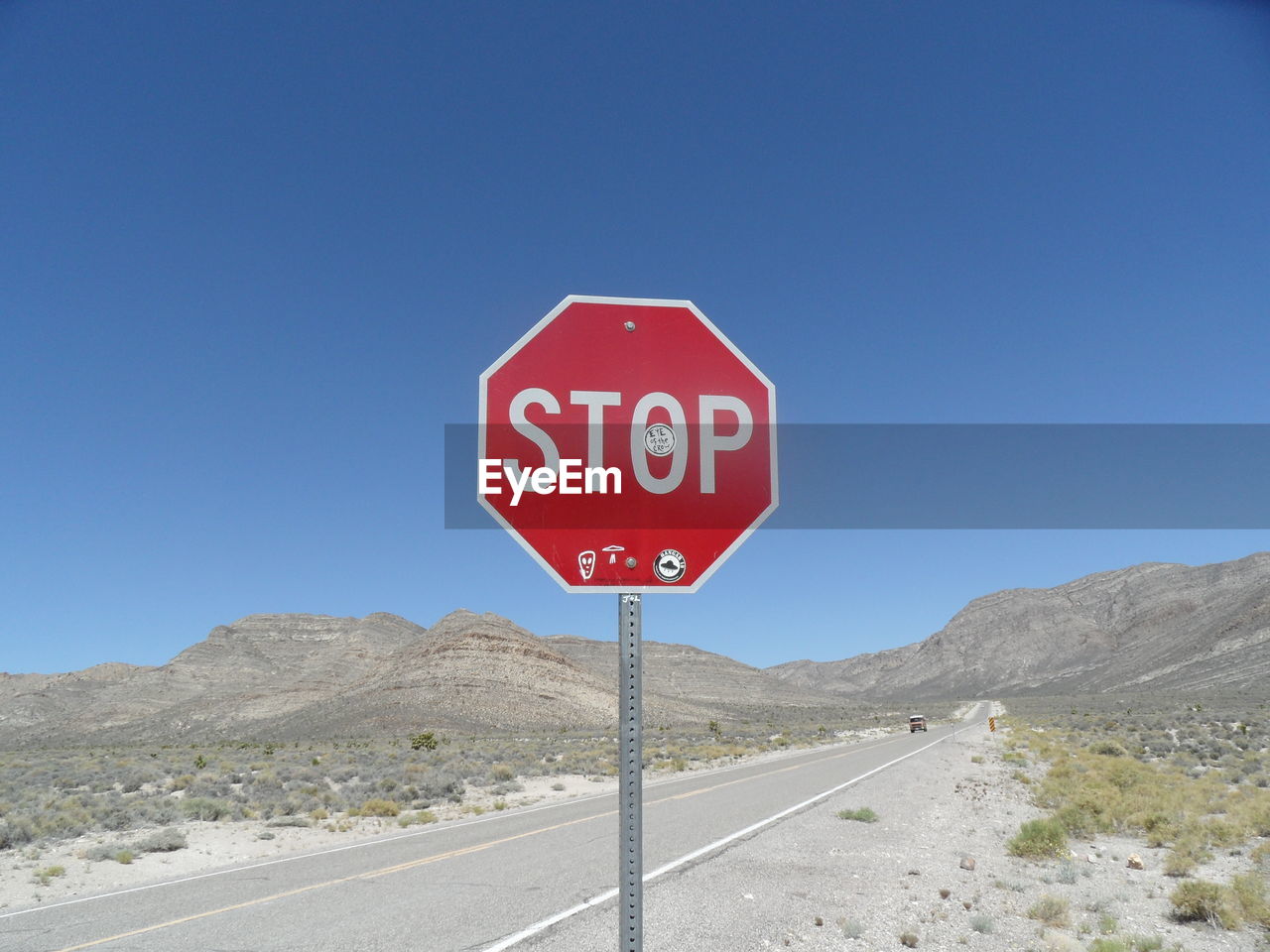 Road sign against clear sky