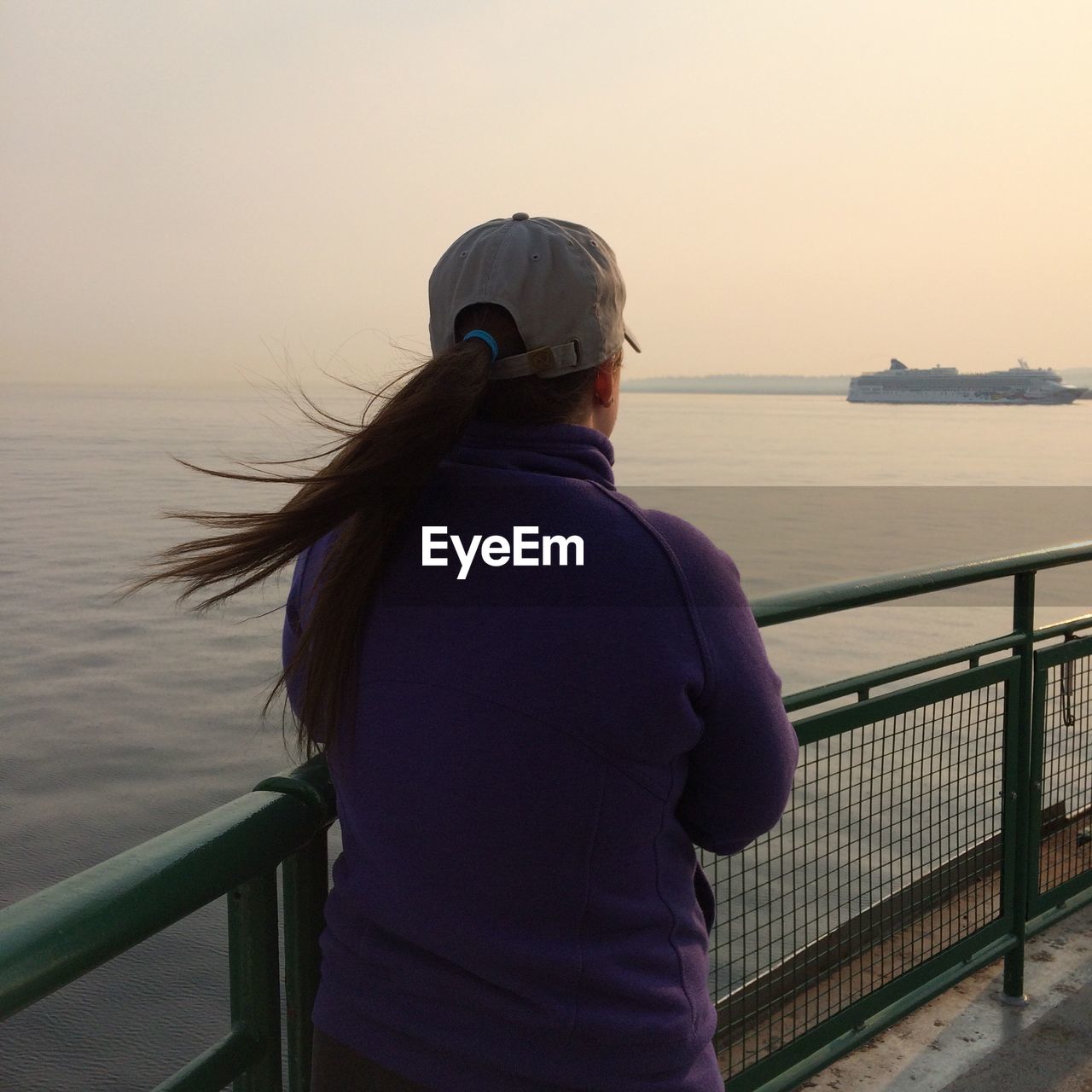 Rear view of woman looking at sea against clear sky