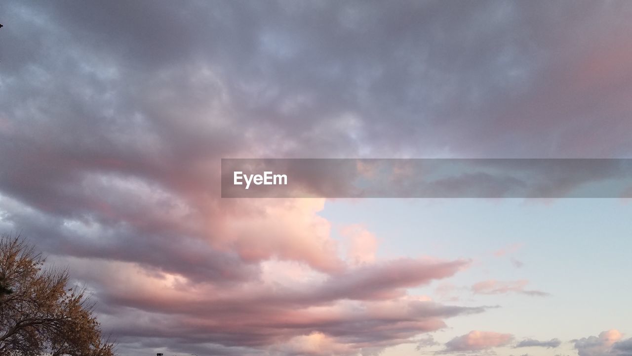 LOW ANGLE VIEW OF STORM CLOUDS OVER DRAMATIC SKY