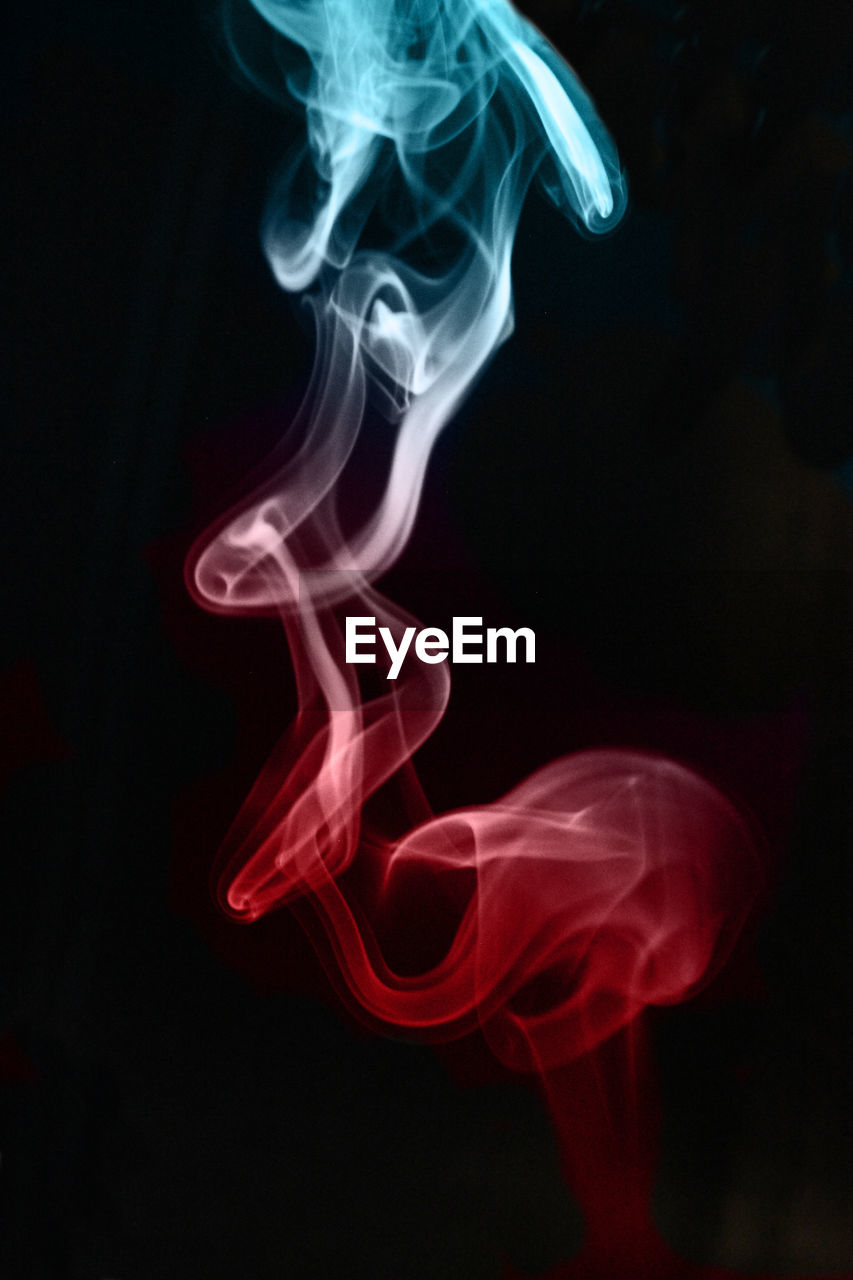 Close-up of smoke moving against black background