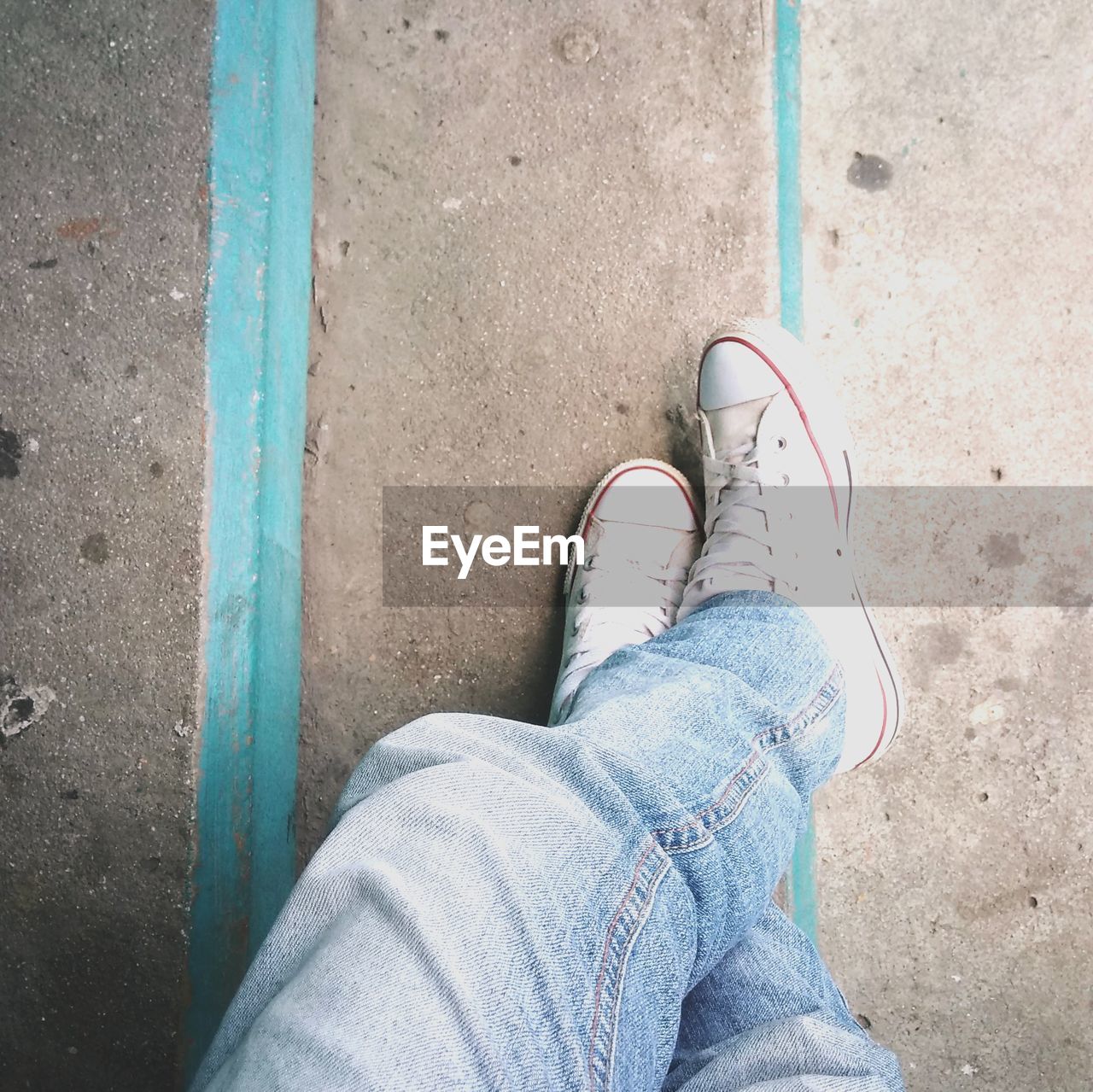 Low section of man wearing shoes while standing on steps