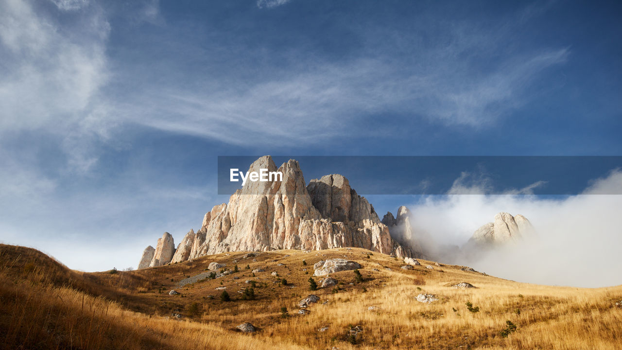 Morning dawn after rain with fog on the alpine of the caucasus mountains. stone castle. adygea