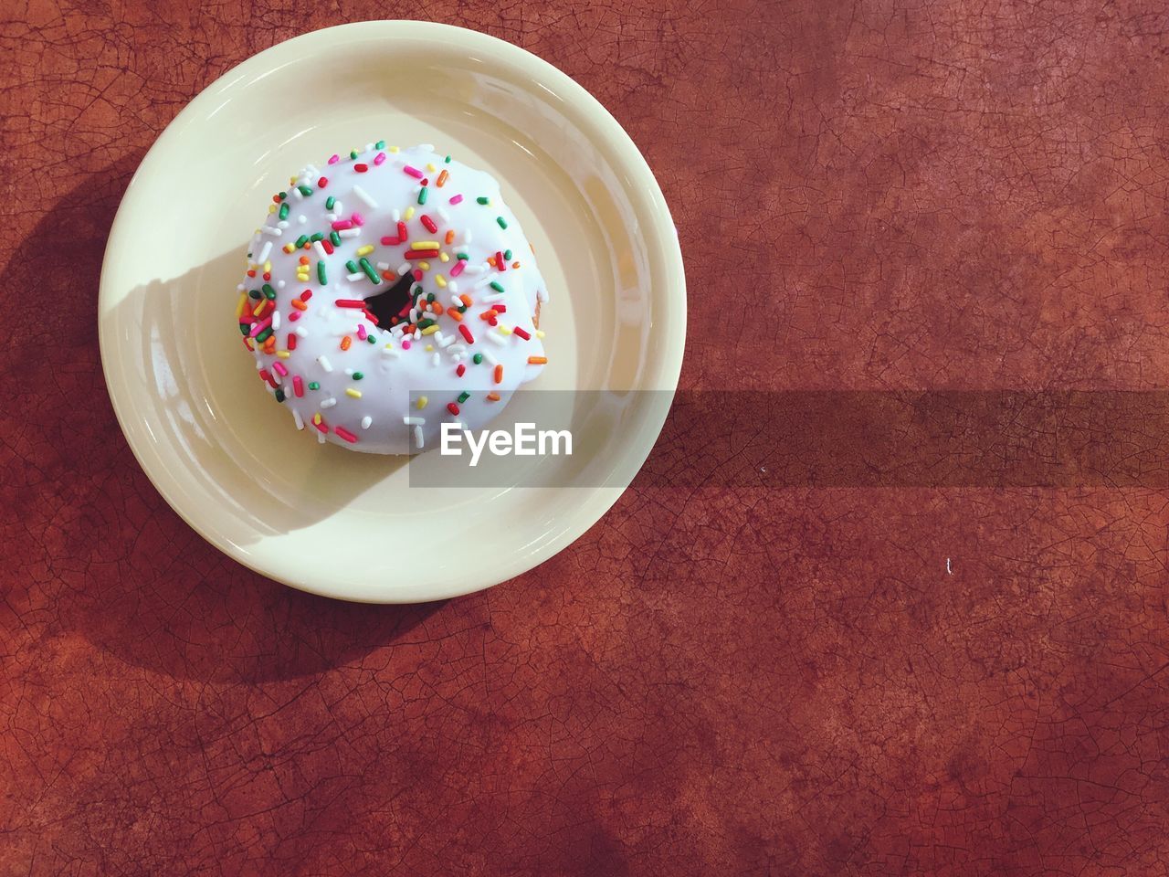 Directly above shot of donut in plate on table