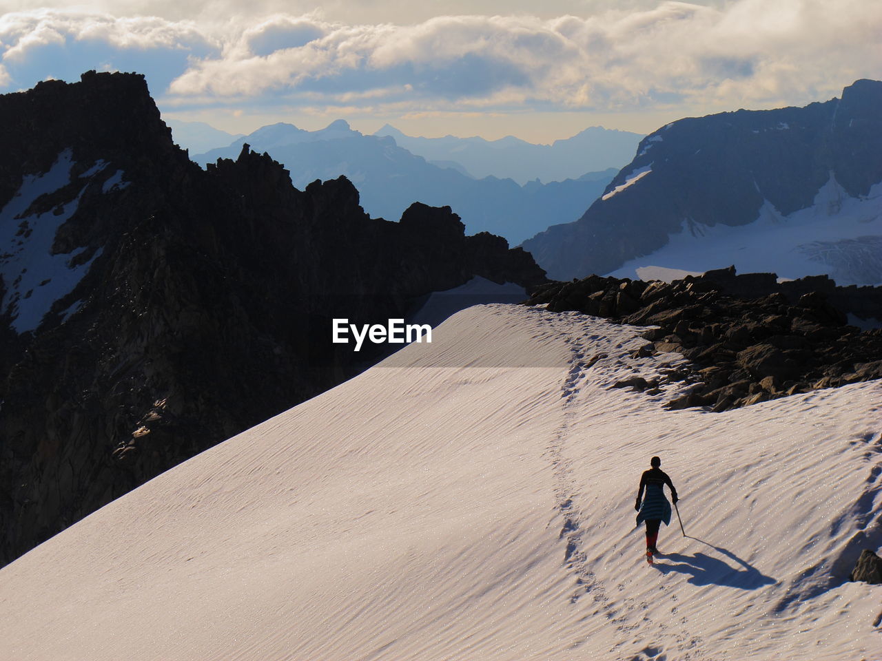 Man walking on snowcapped mountain