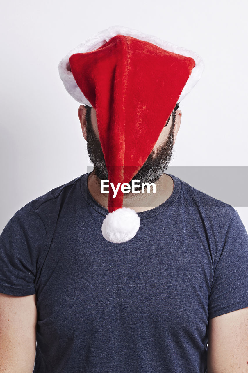 Man wearing santa hat against white background