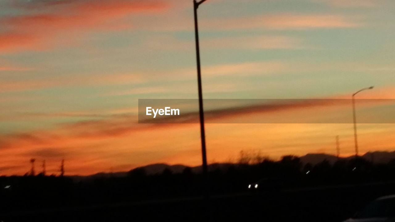 SCENIC VIEW OF SILHOUETTE TREES AGAINST ORANGE SKY