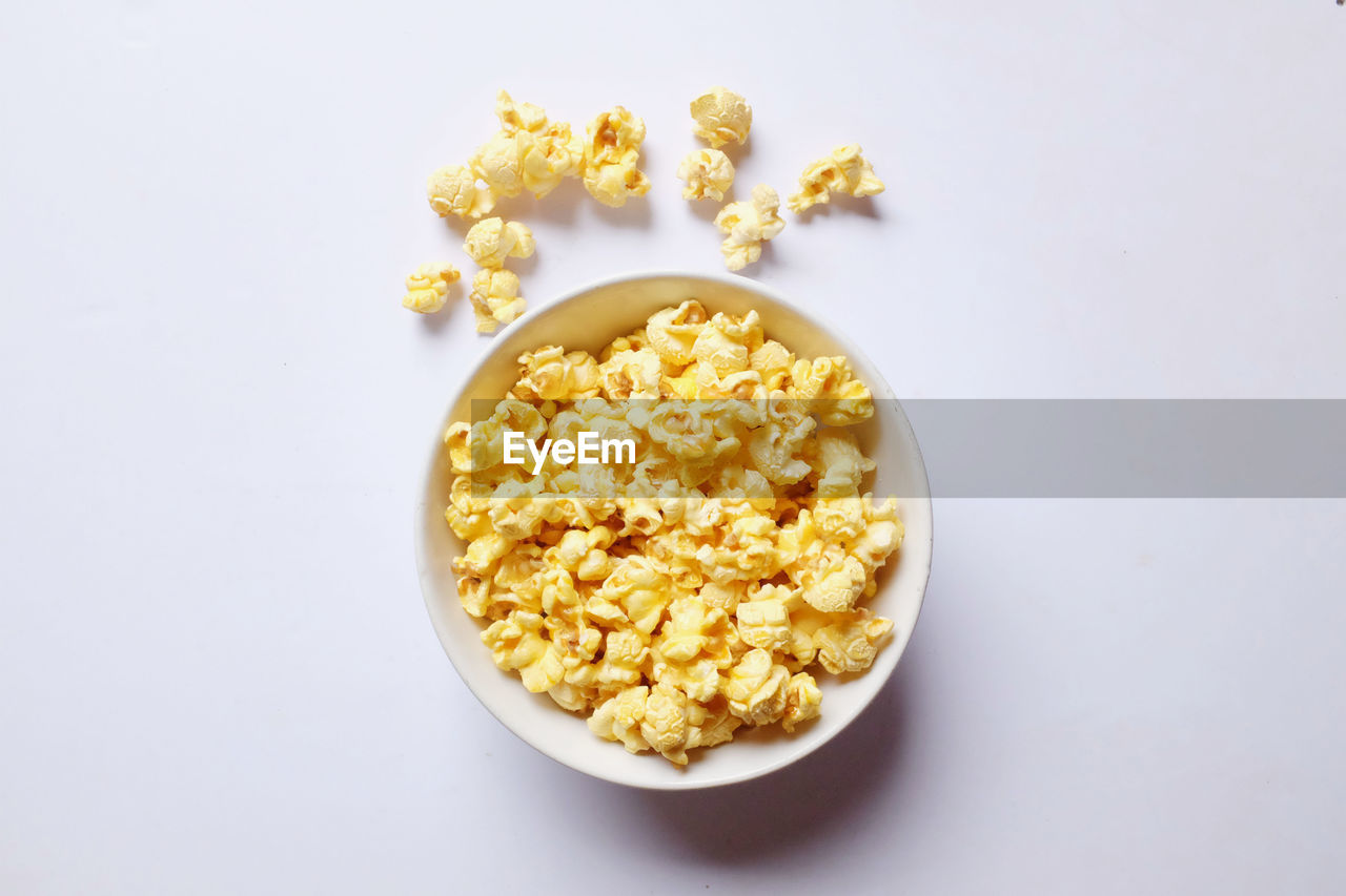 Top view popcorn in a bowl on a white background