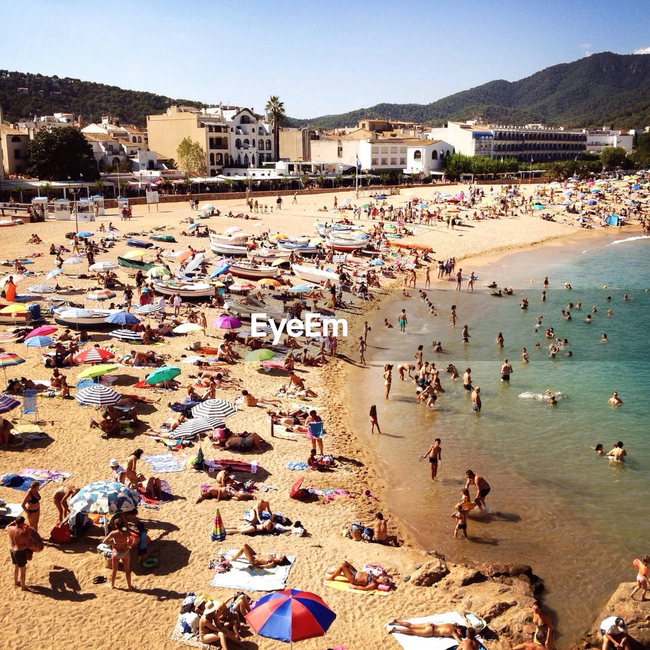 High angle view of tourists enjoying on beach