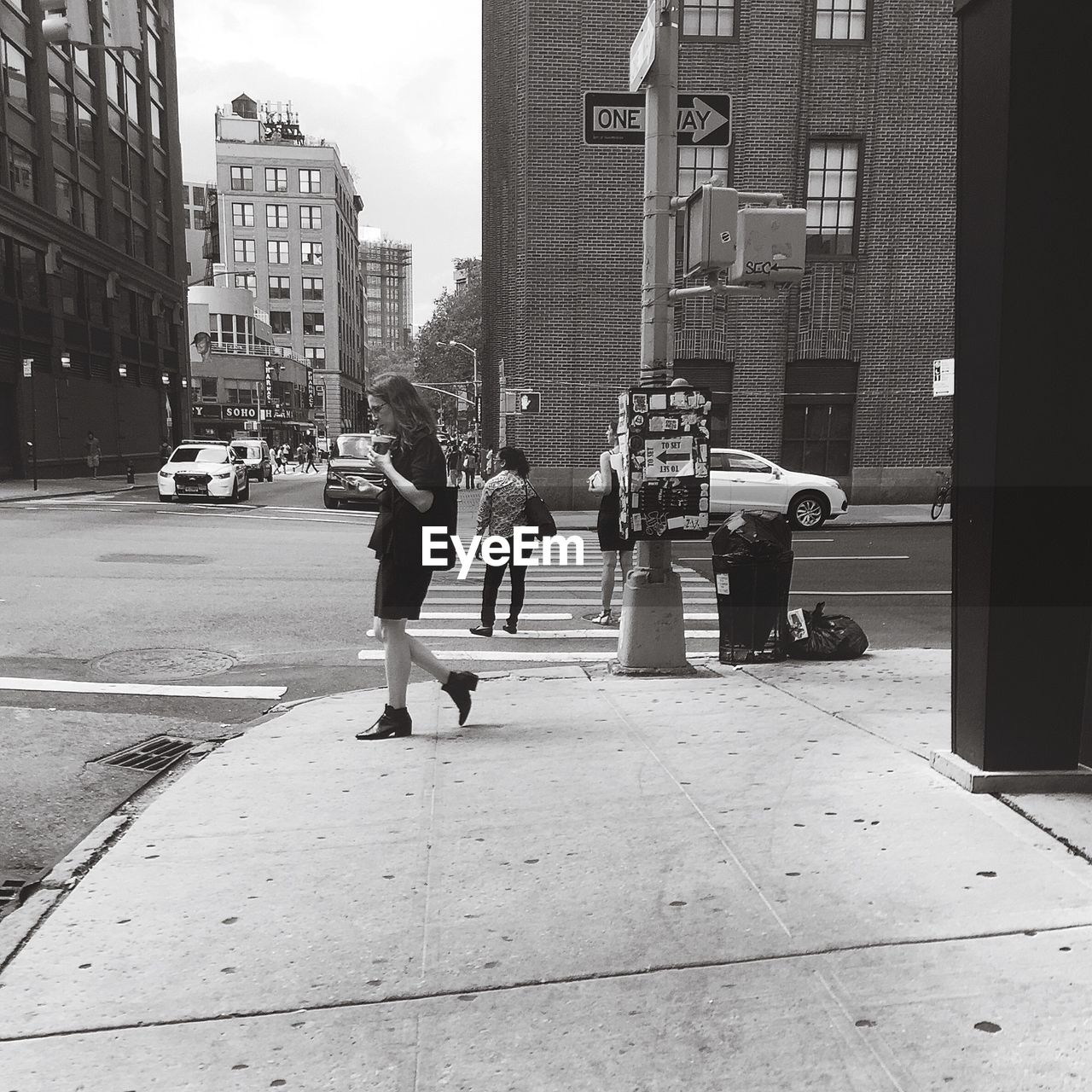 WOMAN WALKING ON CITY STREET