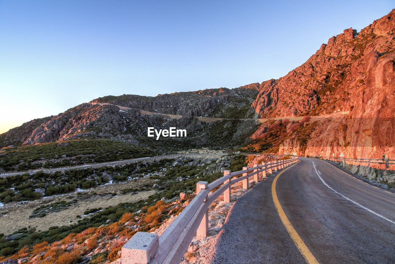 Road by mountain against sky