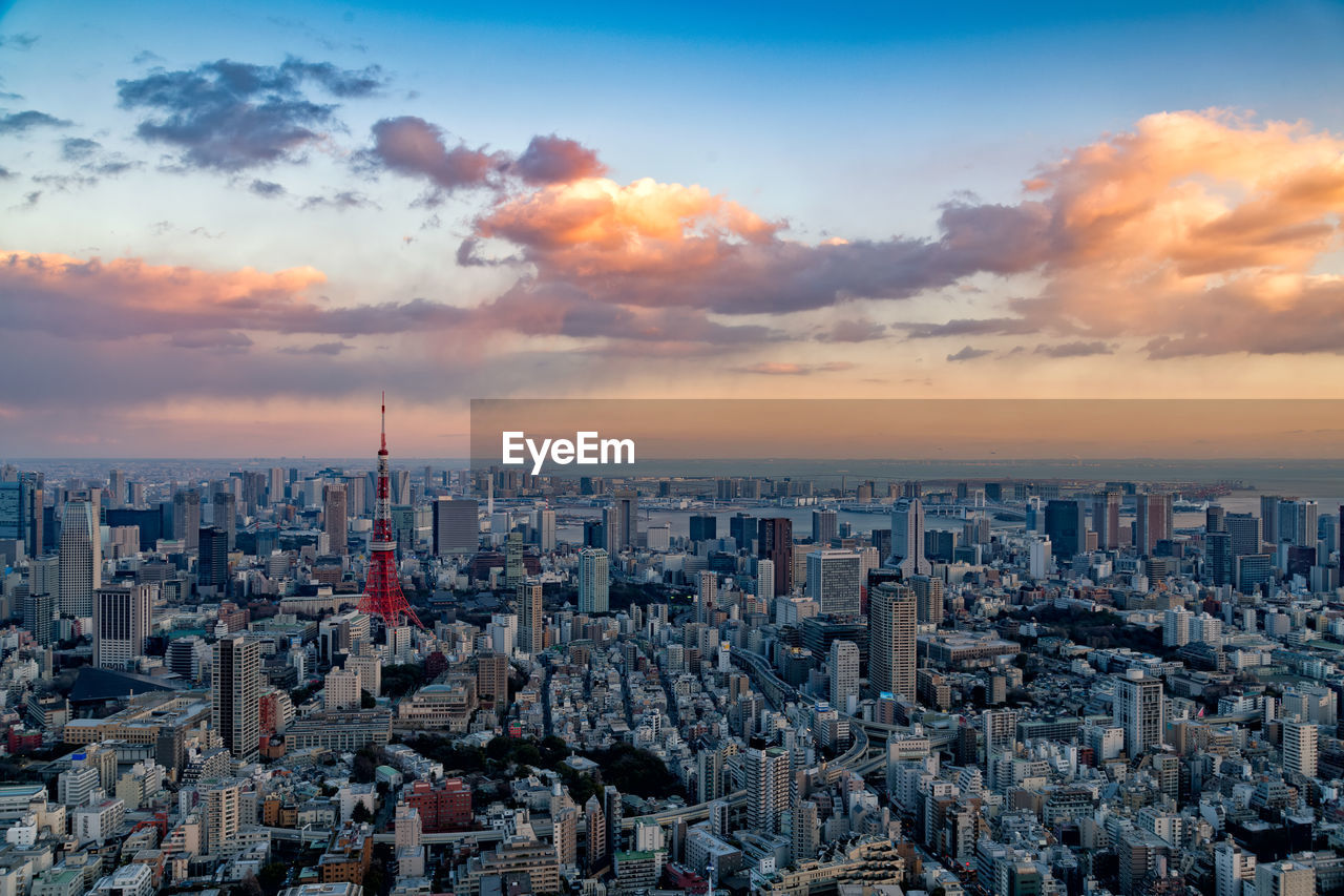 MODERN CITYSCAPE AGAINST SKY DURING SUNSET