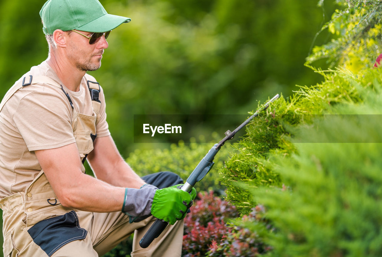 Gardener using pruning sheers at yard