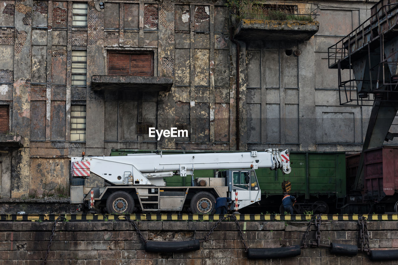 Mobile crane by abandoned building