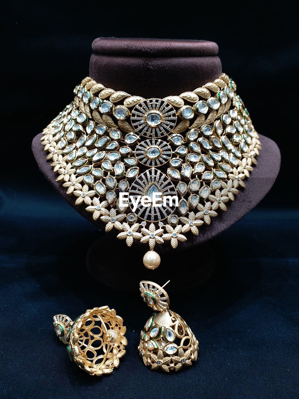 Close-up of jewelry on table against black background