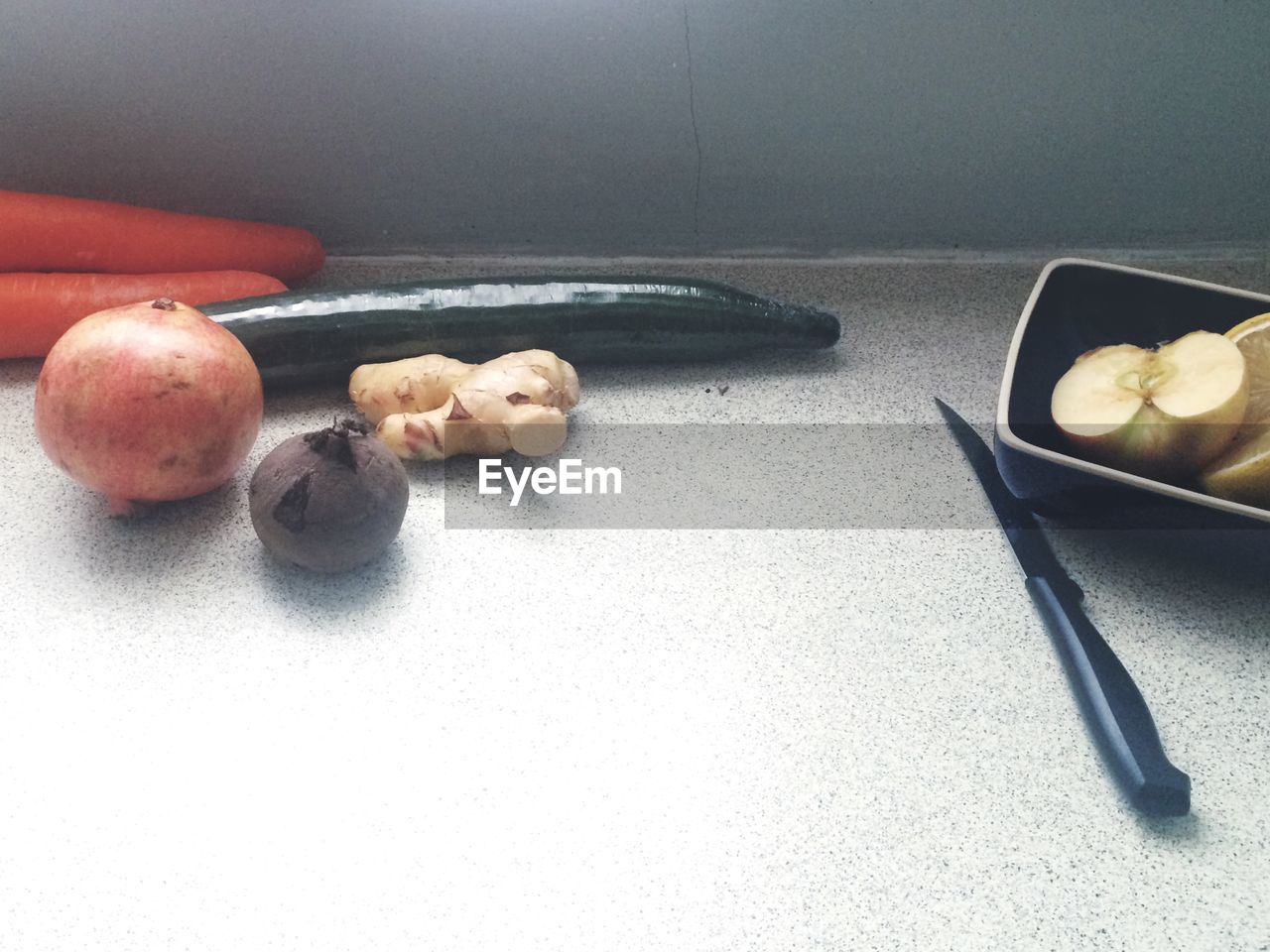 High angle view of vegetables and knife on kitchen counter
