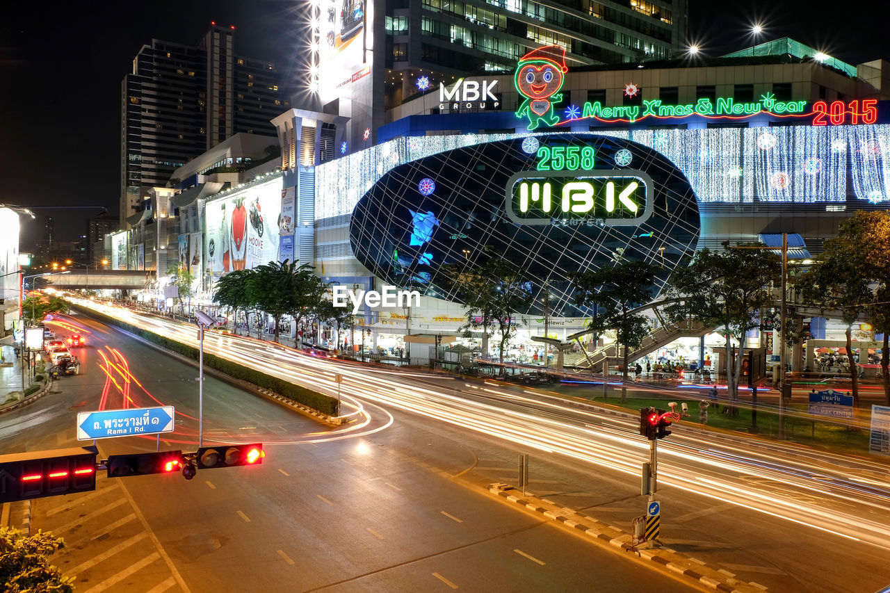 LIGHT TRAILS ON STREET AT NIGHT