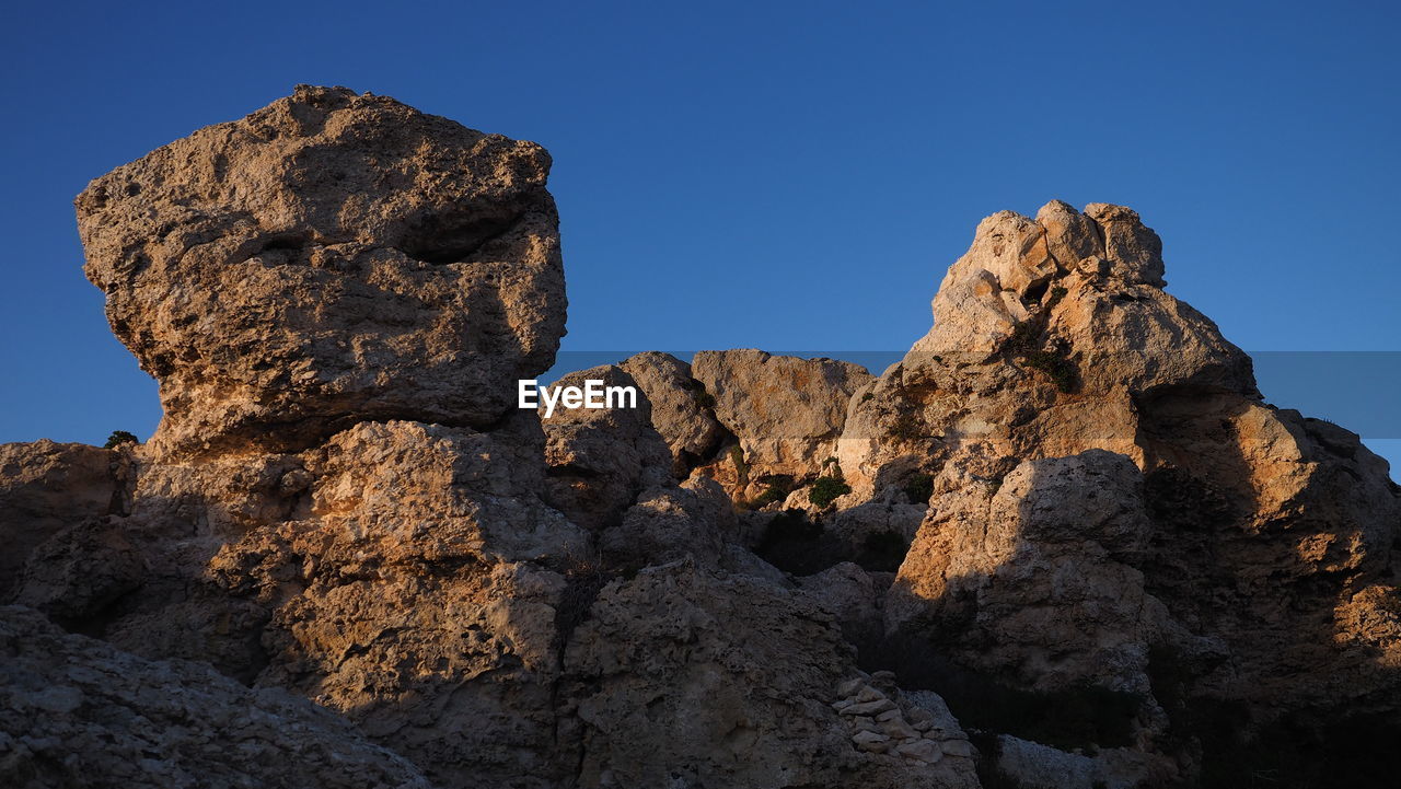 rock, sky, mountain, nature, rock formation, landscape, scenics - nature, travel destinations, clear sky, beauty in nature, environment, blue, no people, land, geology, arch, formation, travel, wilderness, outdoors, non-urban scene, tranquility, natural environment, sunny, physical geography, valley, terrain, desert, sunlight, day, summit, tranquil scene