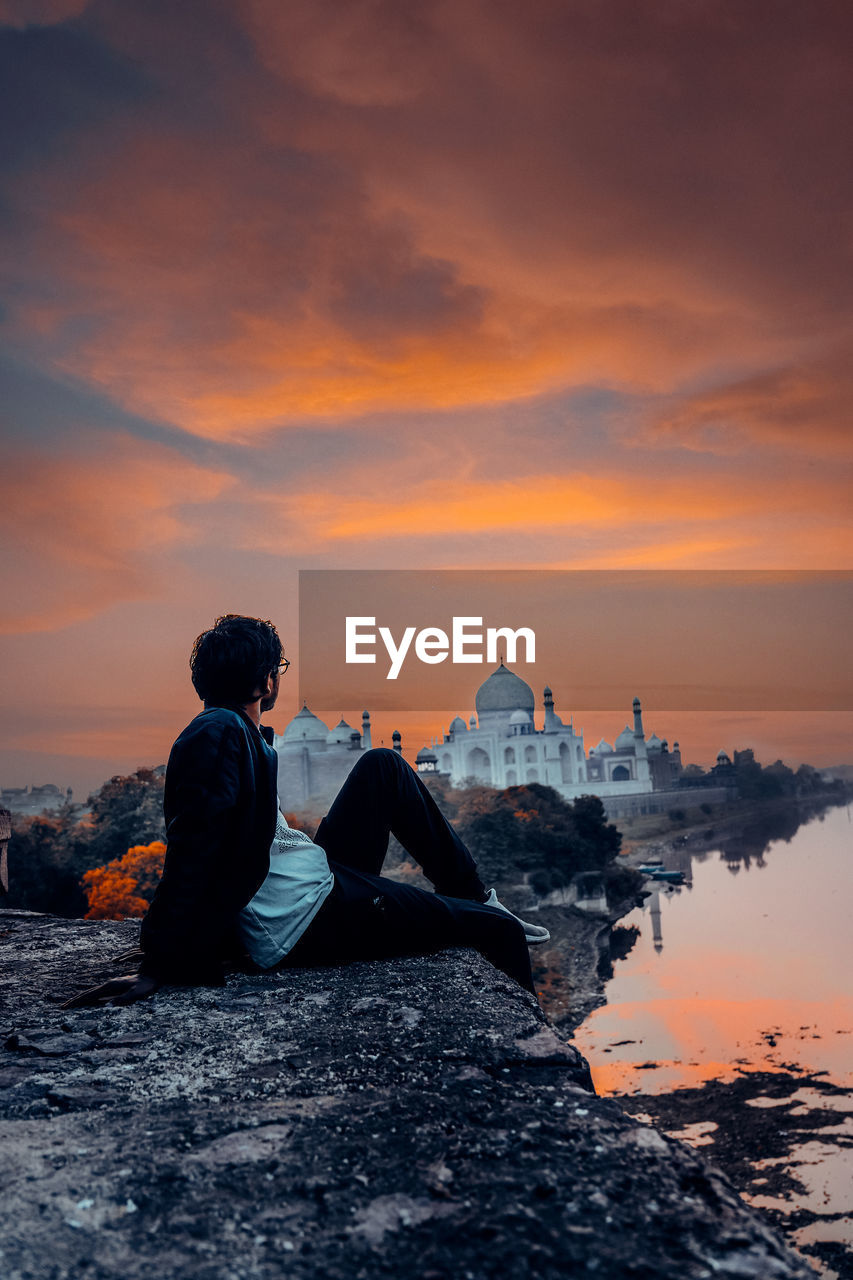 Full length of man looking at taj mahal during sunset