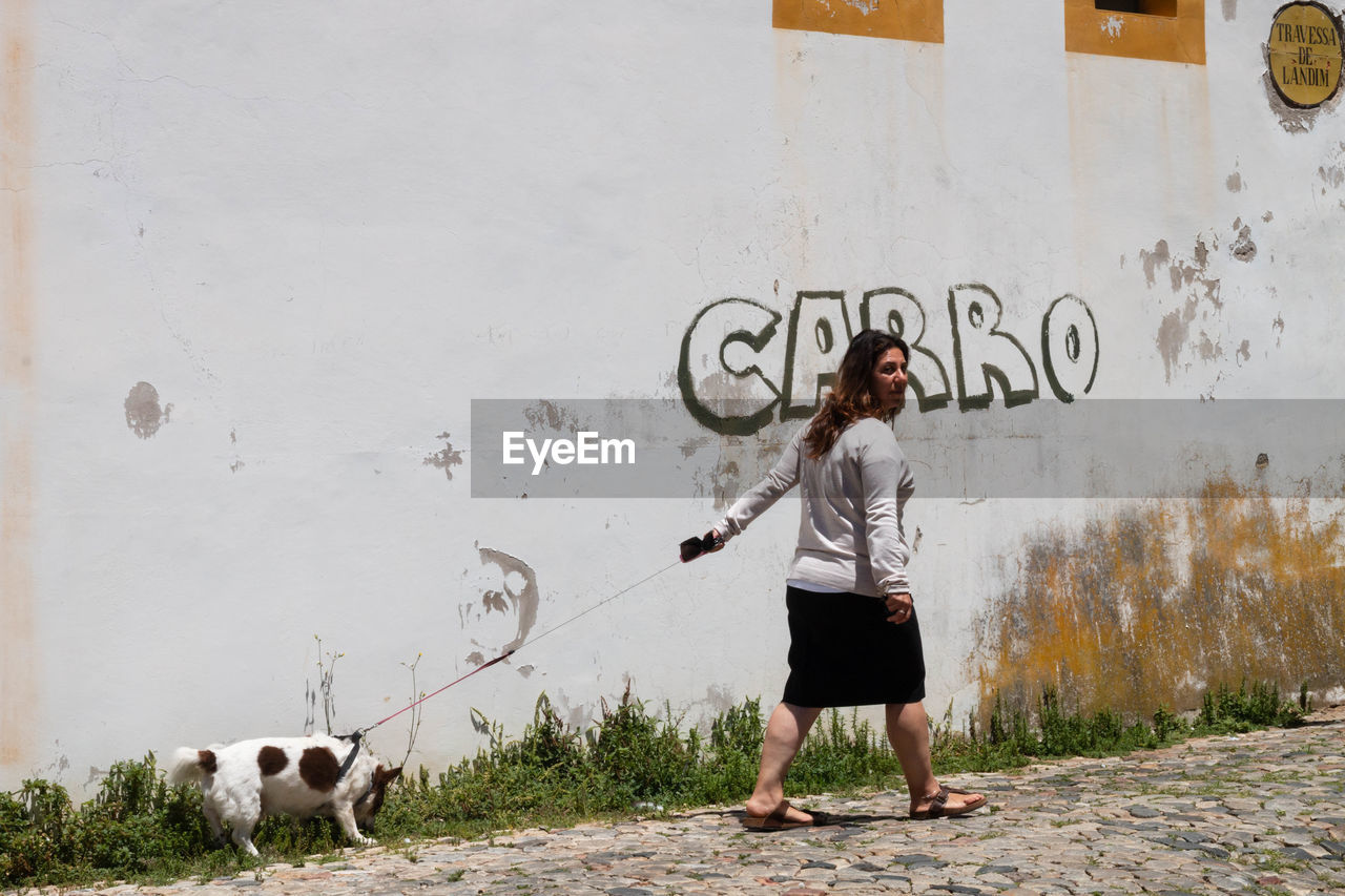 MAN STANDING AGAINST WALL