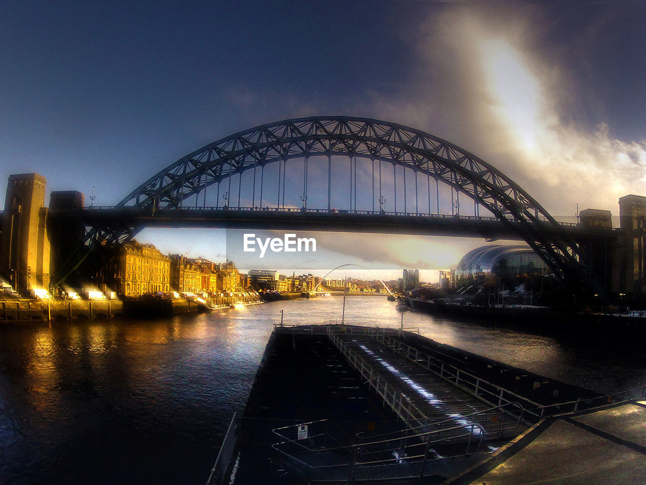 VIEW OF ILLUMINATED BRIDGE AGAINST SKY