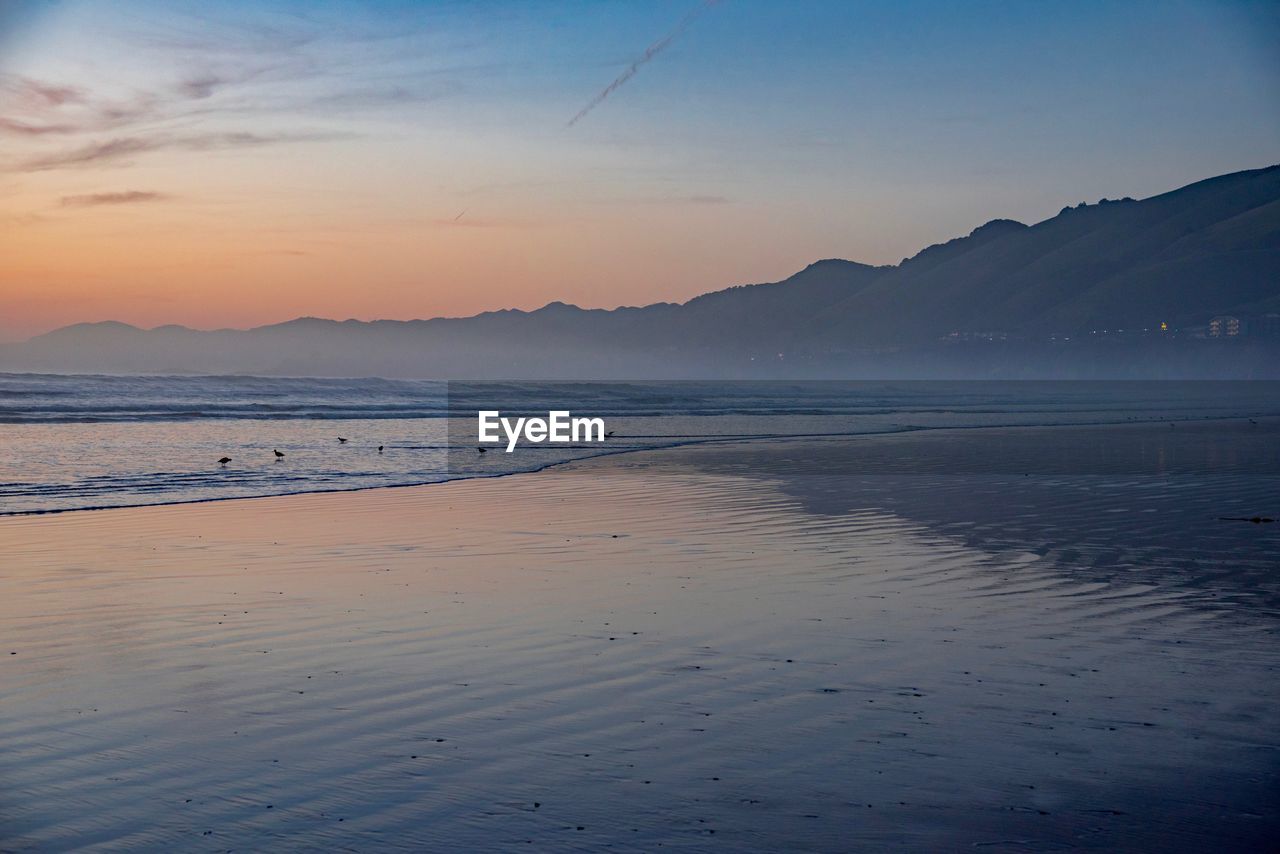 Scenic view of sea against sky during sunset