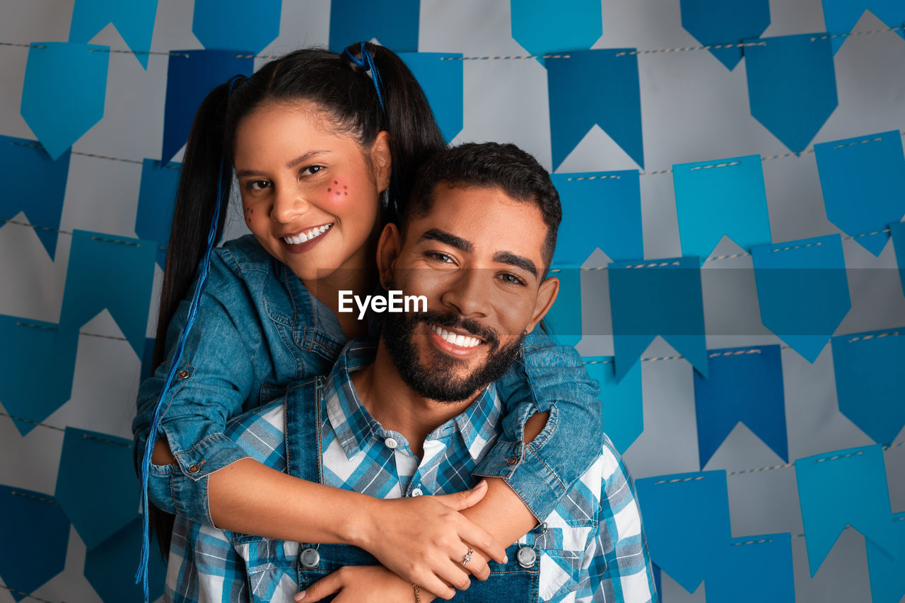 portrait of smiling couple standing against sky