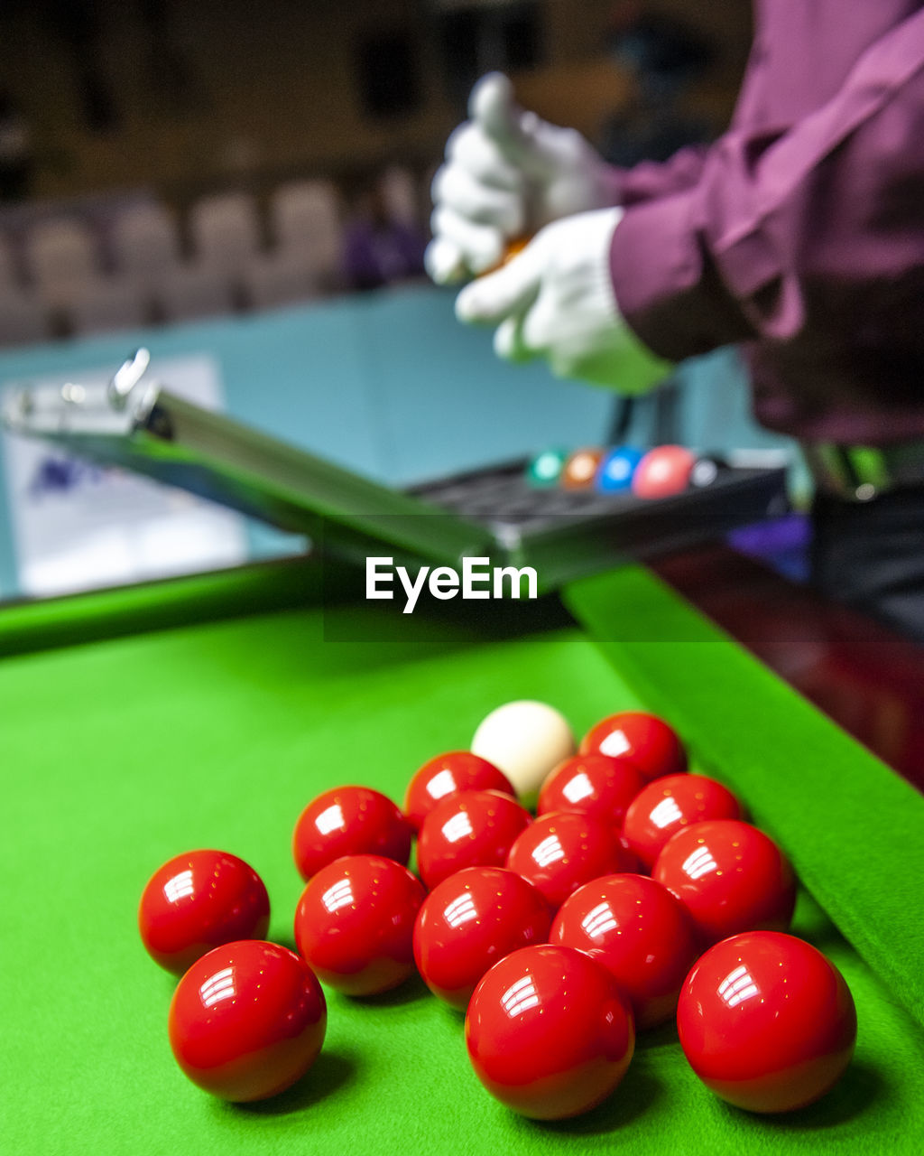 Close-up of hand playing with ball on table