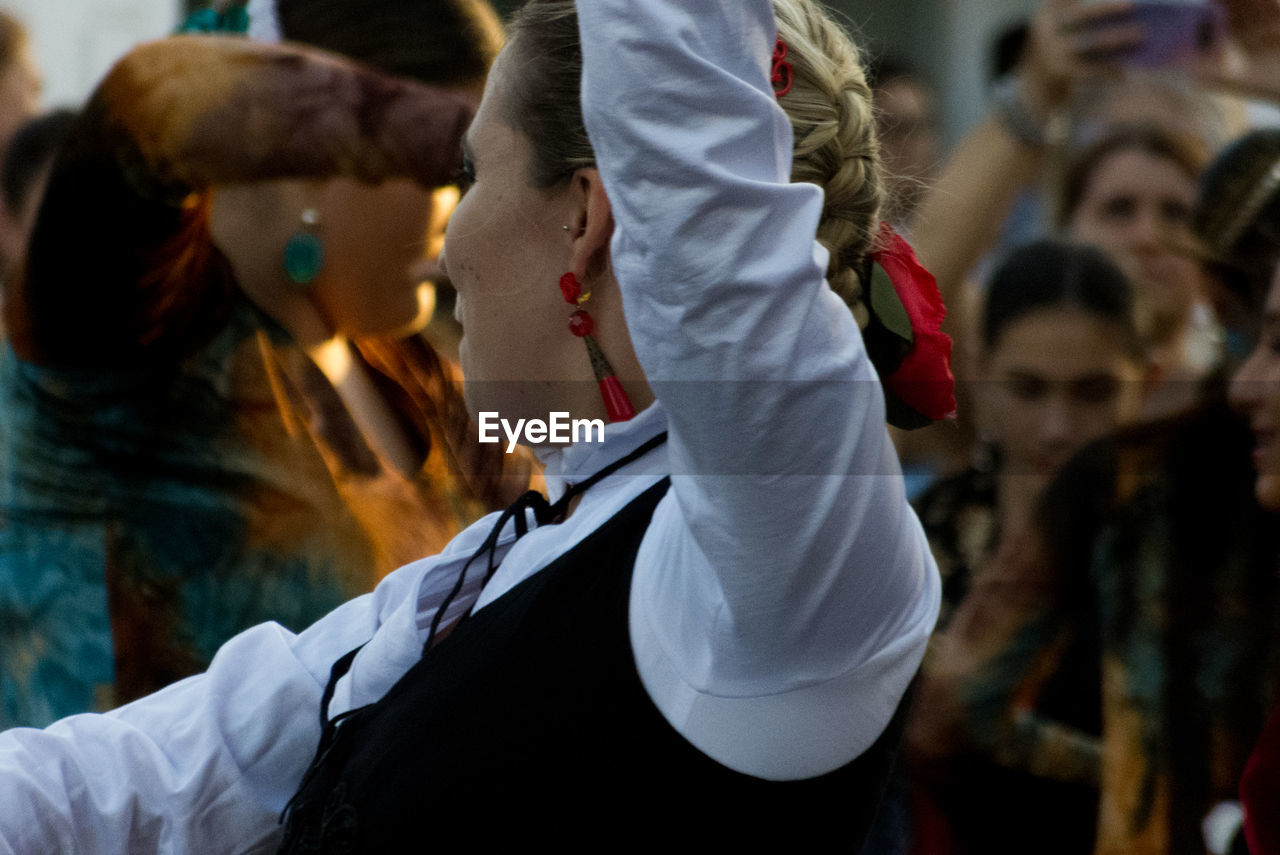 Close-up of people dancing in traditional clothing