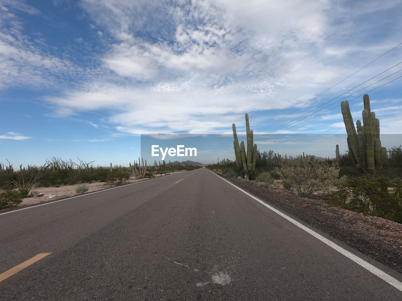 EMPTY ROAD AGAINST SKY IN CITY