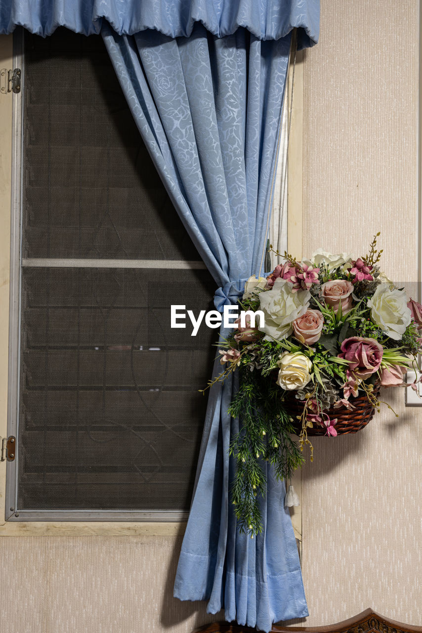 CLOSE-UP OF ROSES AGAINST WHITE DOOR