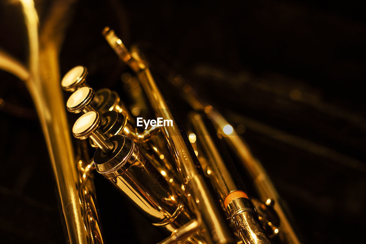 CLOSE-UP OF ILLUMINATED LIGHTING EQUIPMENT AGAINST BLACK BACKGROUND
