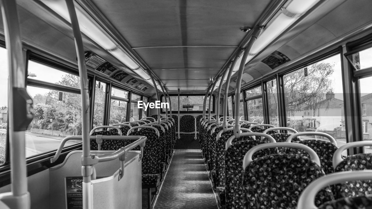 transport, vehicle interior, vehicle seat, transportation, mode of transportation, vehicle, public transportation, seat, rail transportation, bus, train, land vehicle, black and white, public transport, travel, subway train, window, indoors, monochrome, passenger, in a row, monochrome photography, train interior, passenger train, journey, empty, day, commuter, absence