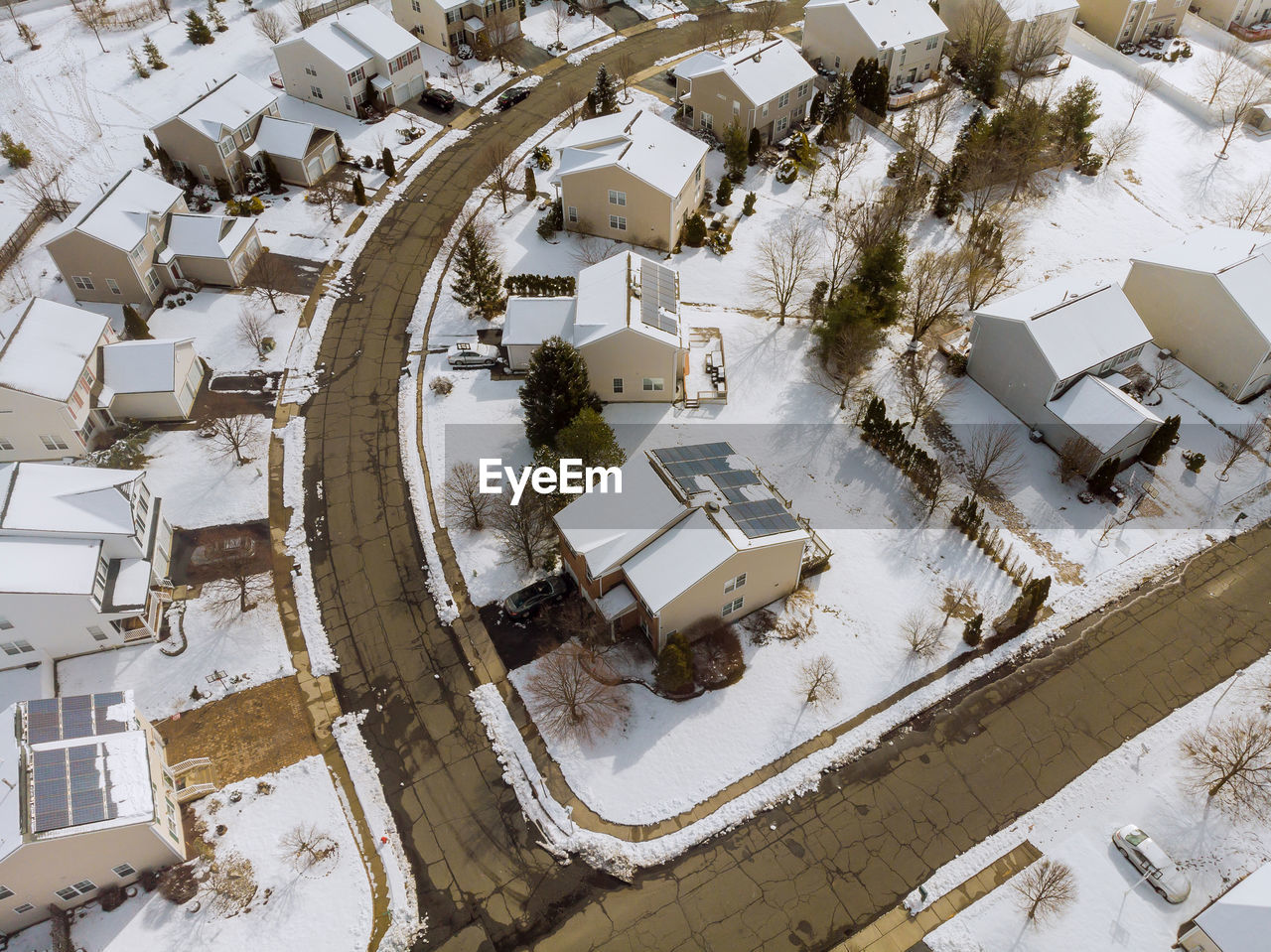 HIGH ANGLE VIEW OF SNOW COVERED FIELD BY BUILDING