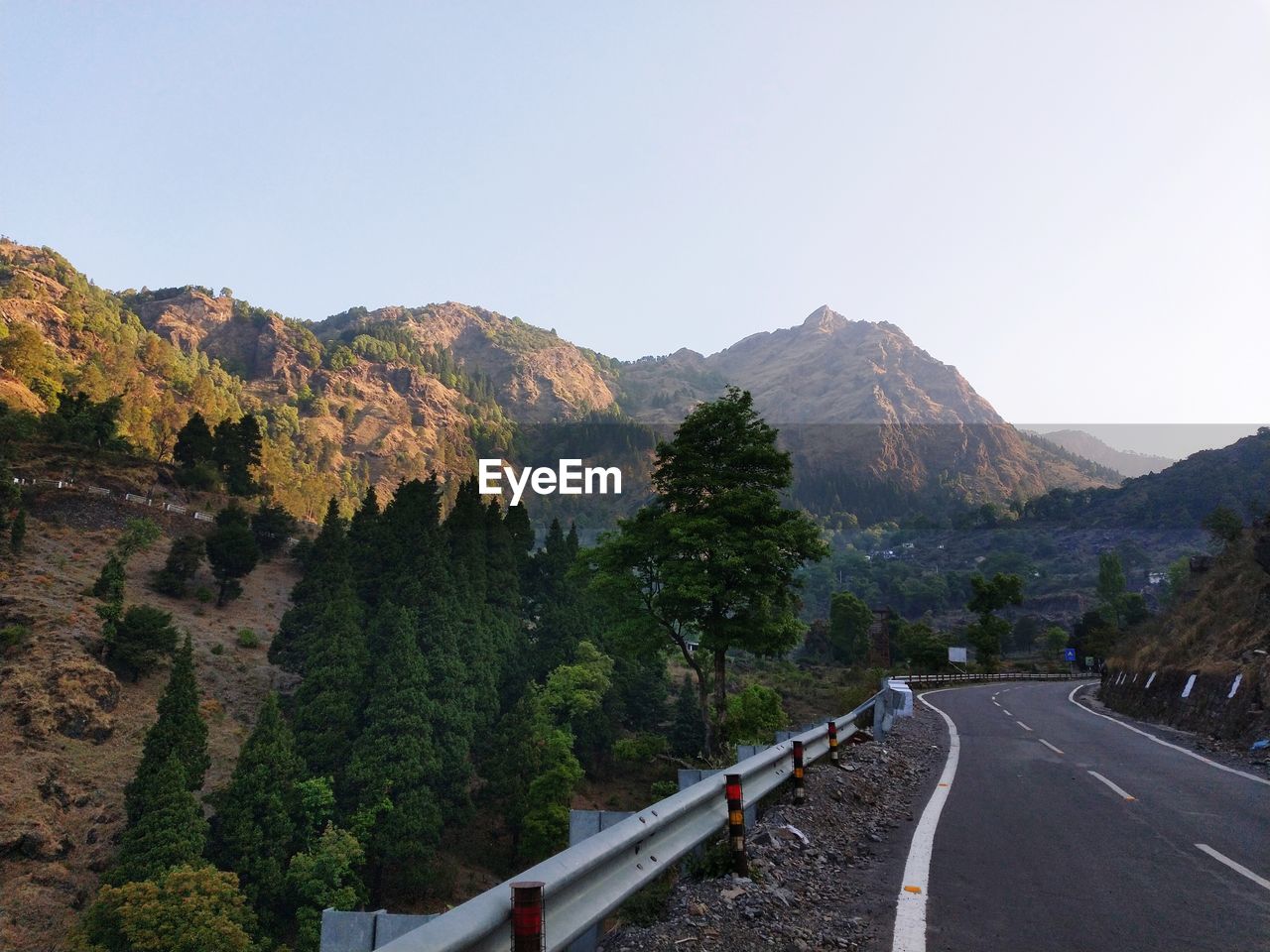 PANORAMIC VIEW OF ROAD BY MOUNTAINS AGAINST SKY